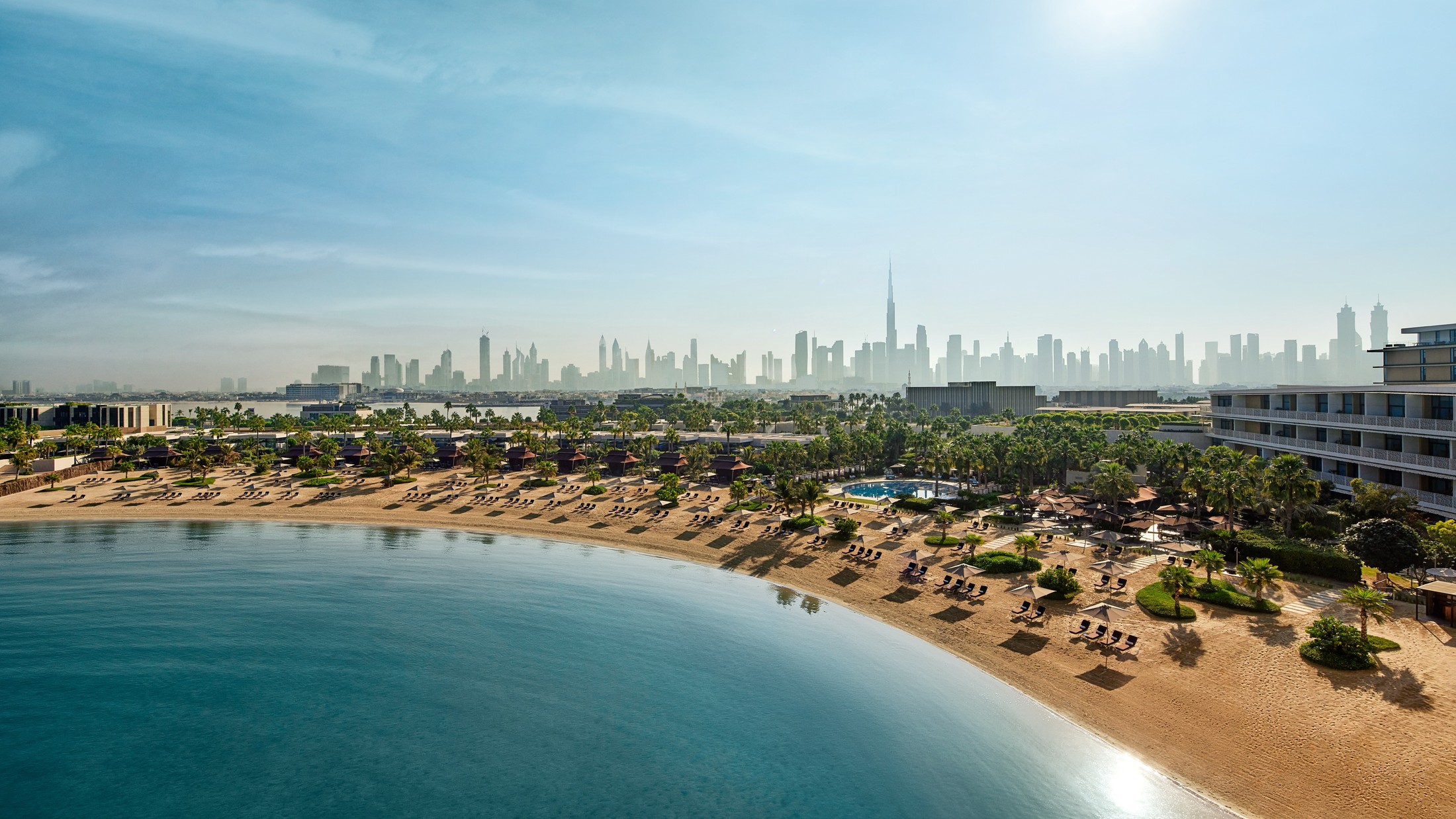 Bvlgari Resort Dubai's beach with the Dubai skyline beyond