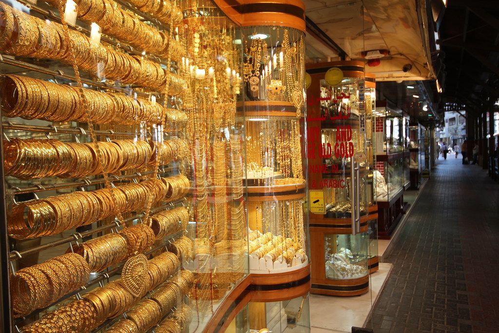 Shop windows hung with gold bangles and necklaces along a covered lane of the Gold Souk