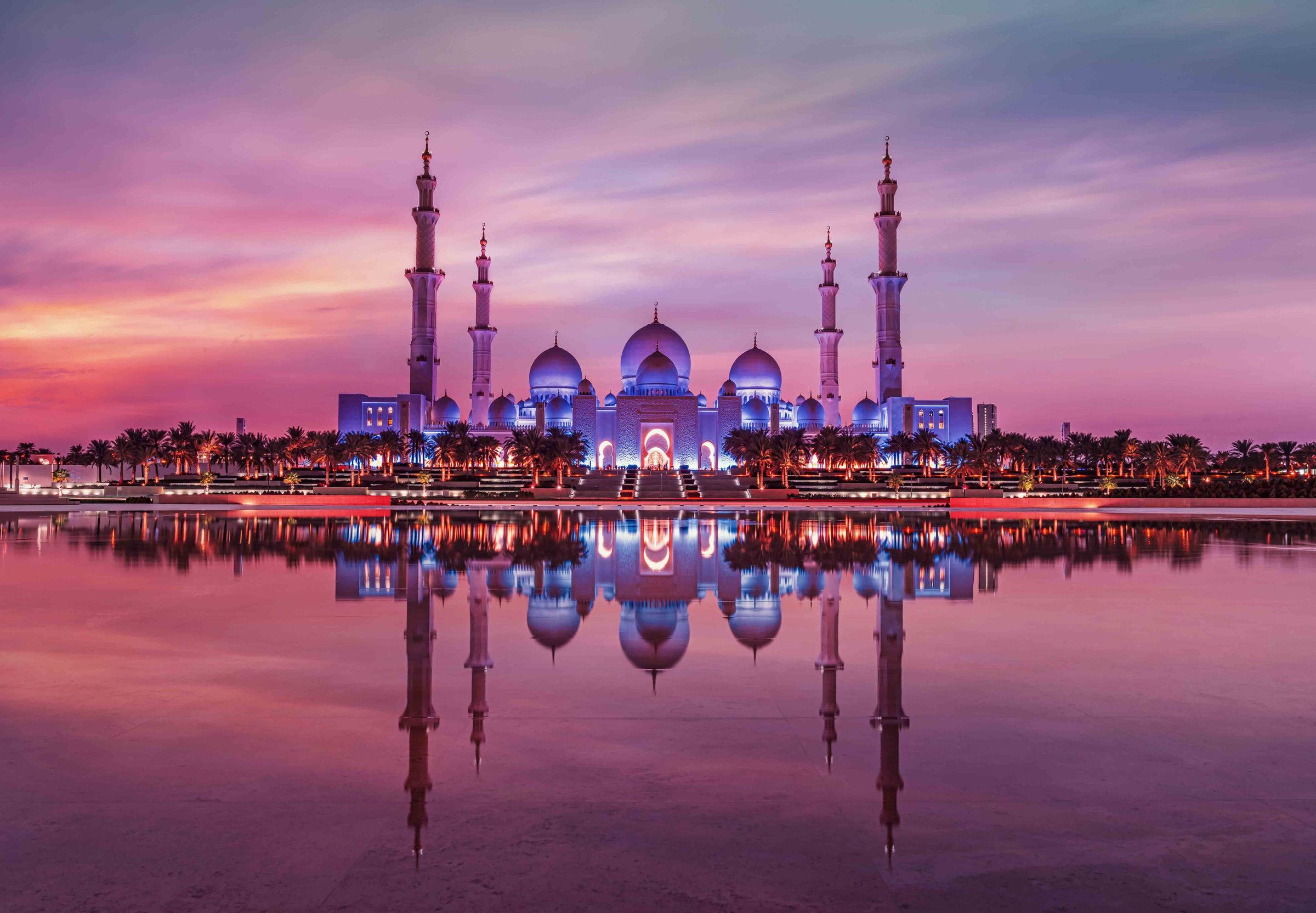 Sheikh Zayed Grand Mosque at dusk, reflected in the water