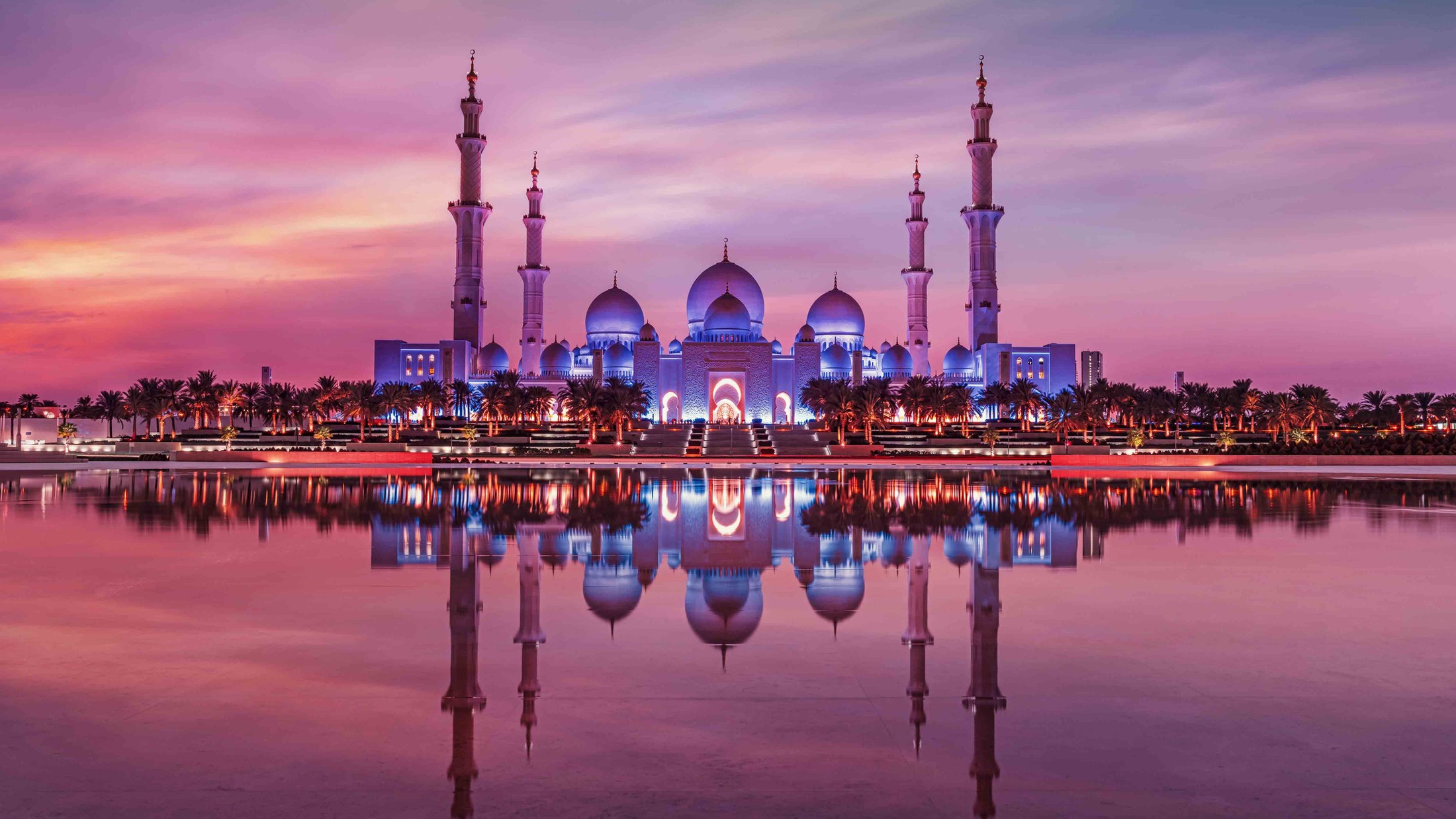 Sheikh Zayed Grand Mosque at dusk, reflected in the water