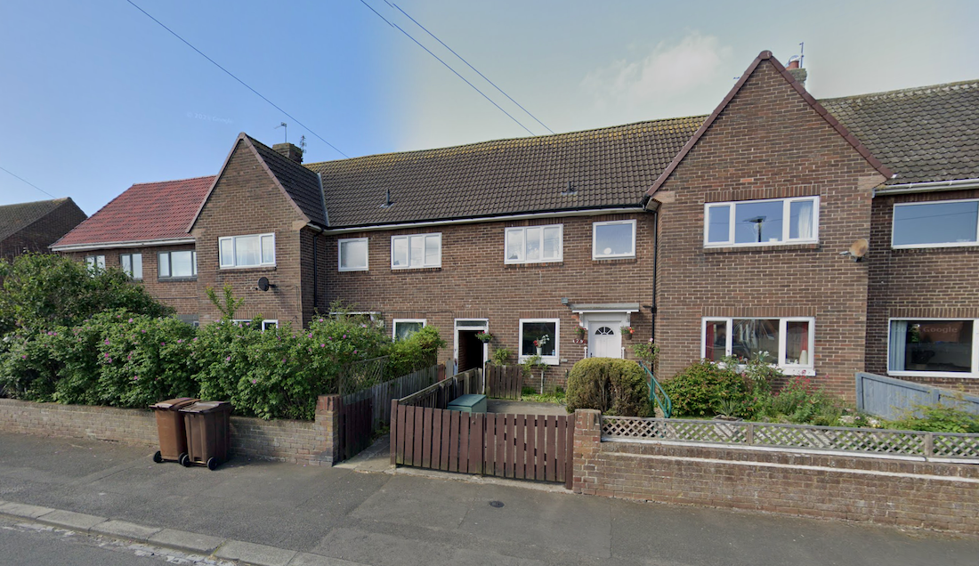 A terrace of council houses in brown brick with rendered panels, front gardens behind low walls and hedges