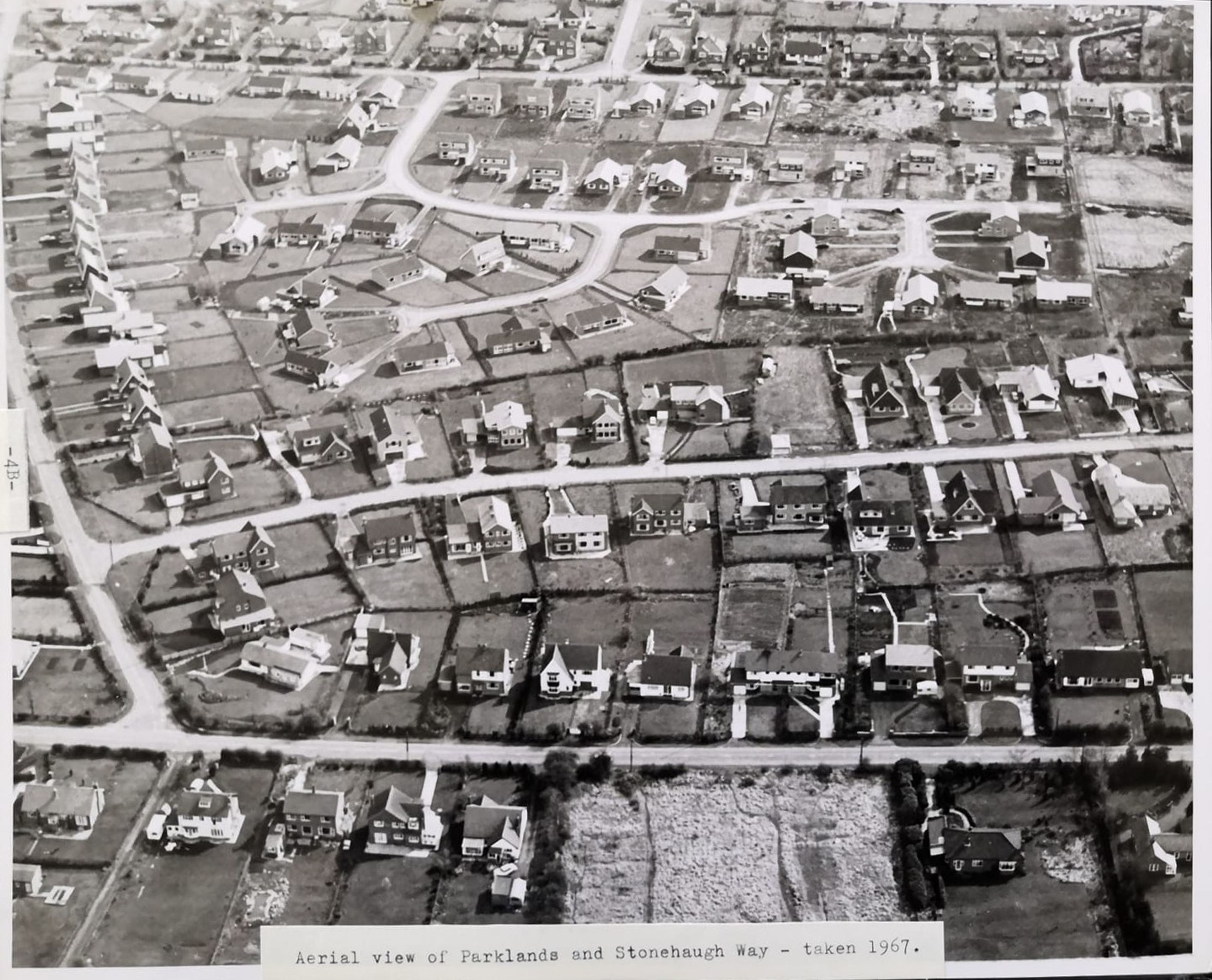 Black and white aerial photograph of a 1960s estate of bungalows and houses, captioned as a view of Parklands and Stonehaugh Way taken in 1967