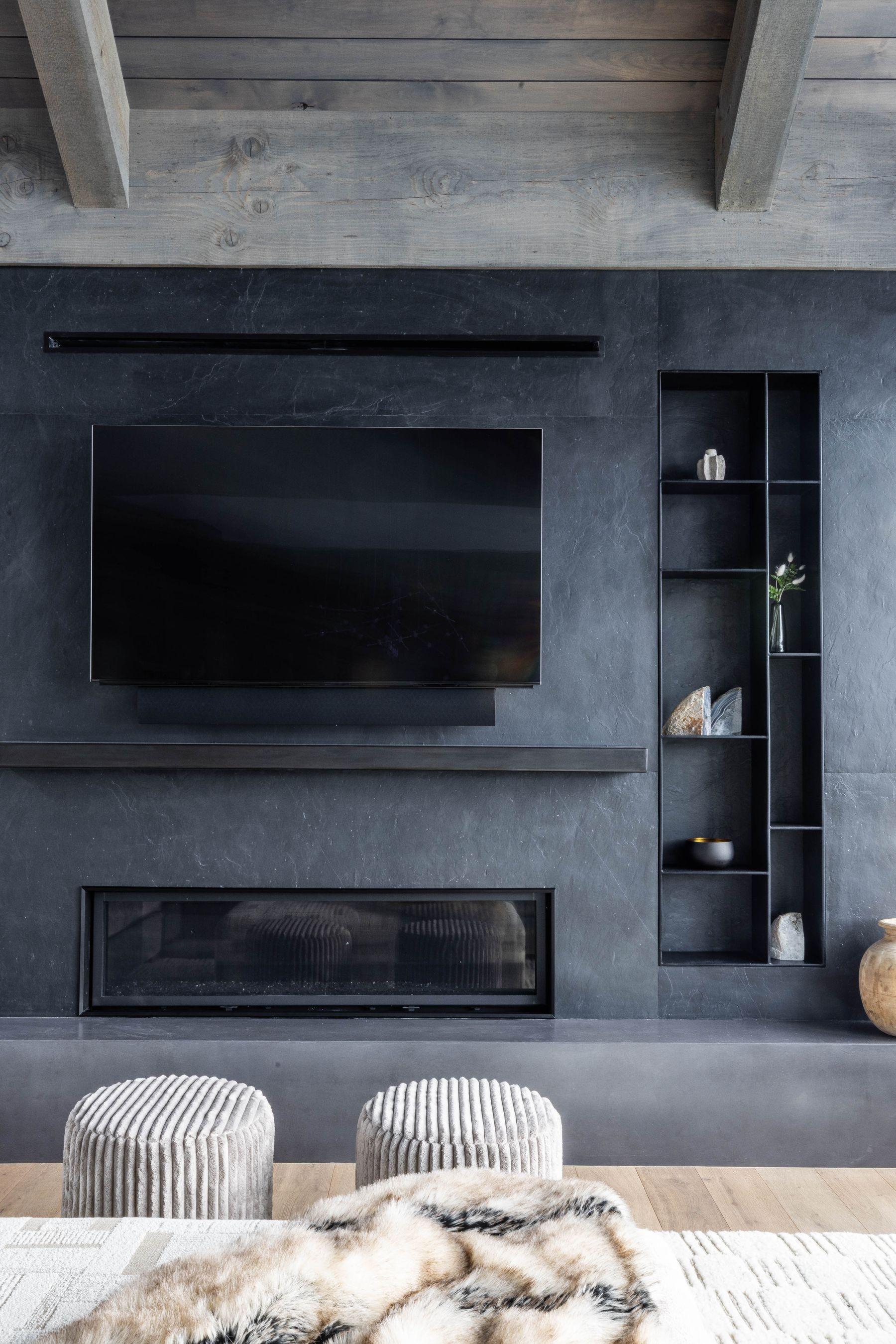 Television wall set into stone above the fireplace