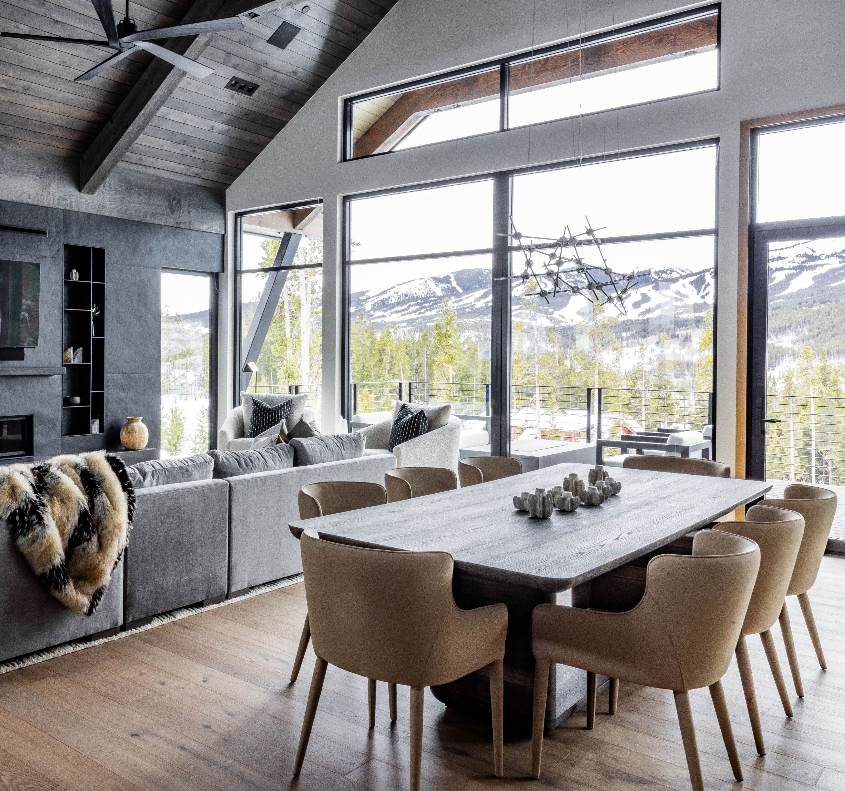 Great room and dining table of an Iron Forest home, with windows onto the Tenmile Range