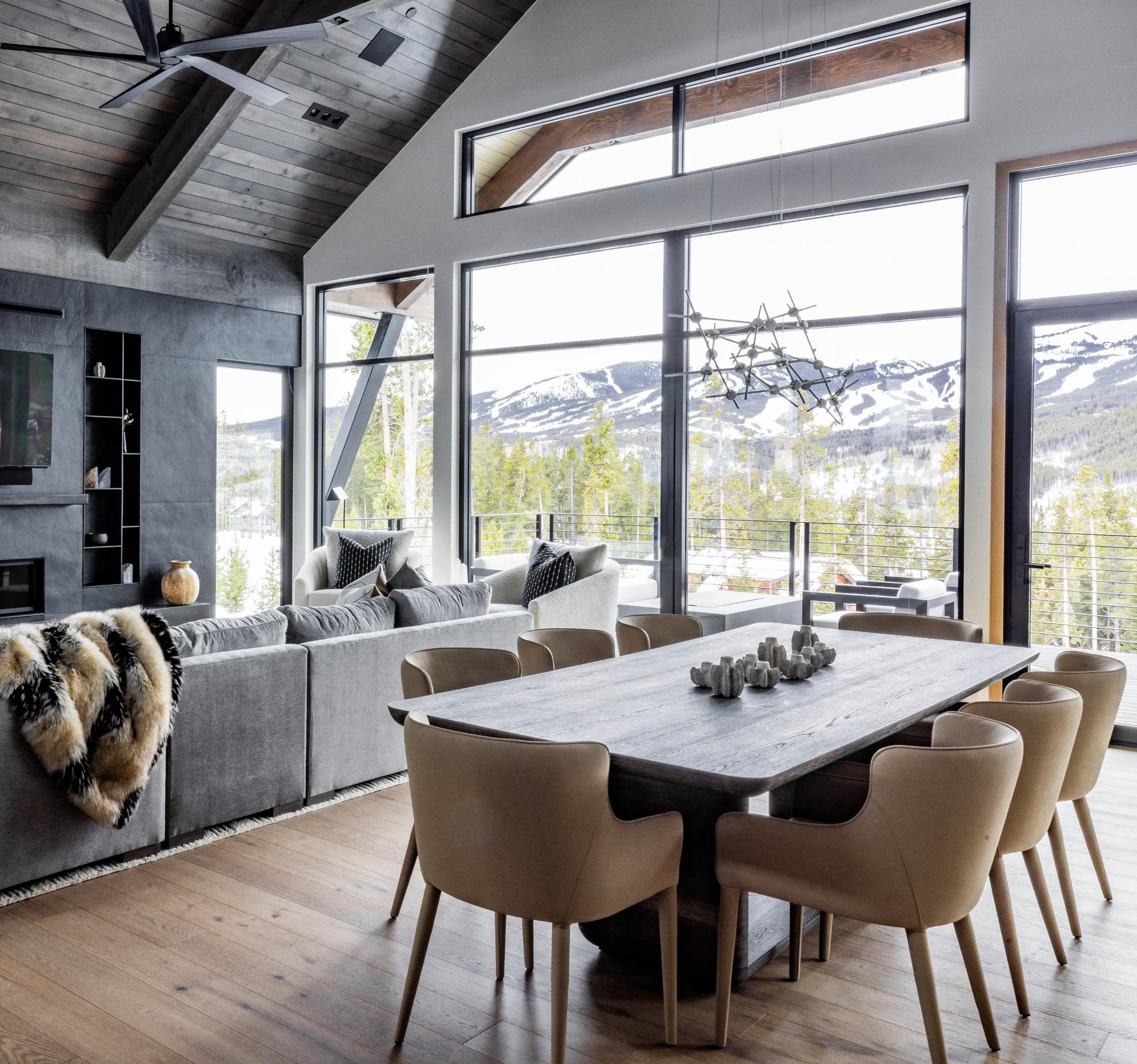 Great room and dining table of an Iron Forest home, with windows onto the Tenmile Range