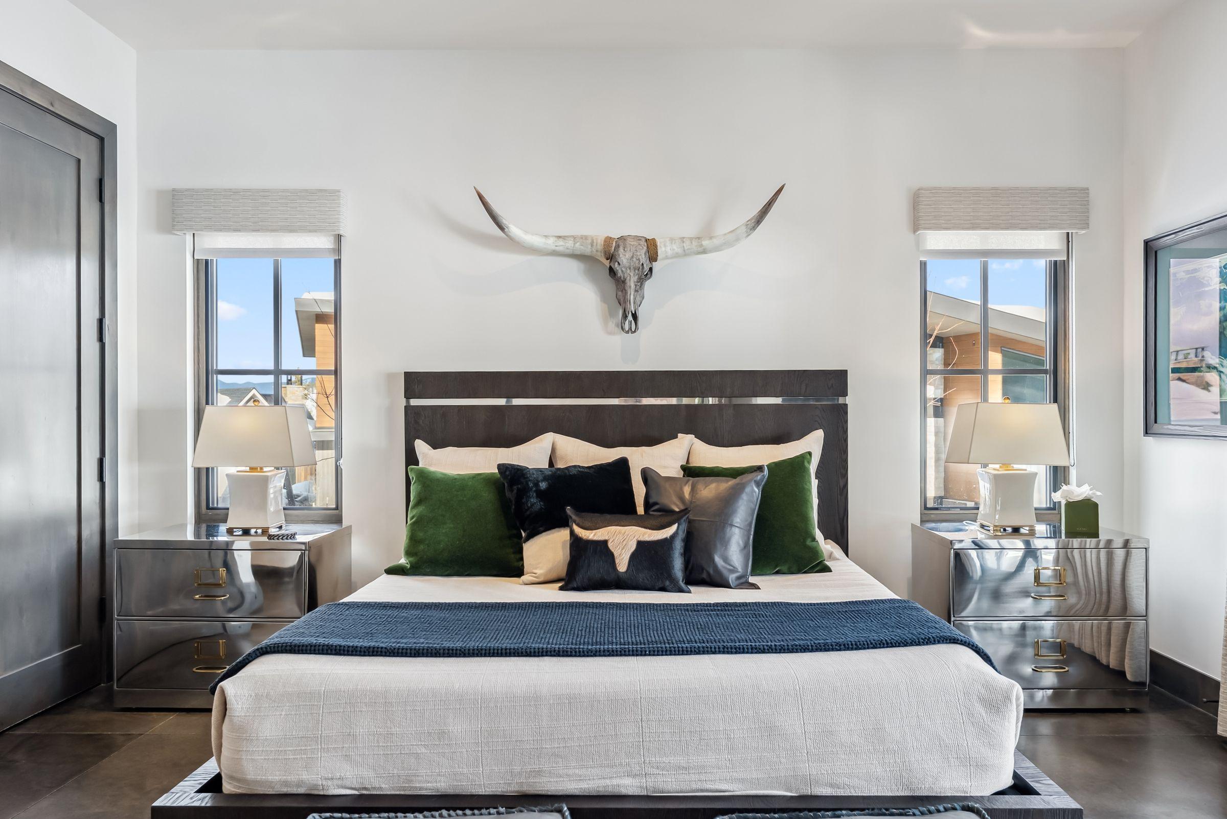 Bedroom with a longhorn skull above the bed and a window onto the Tenmile Range