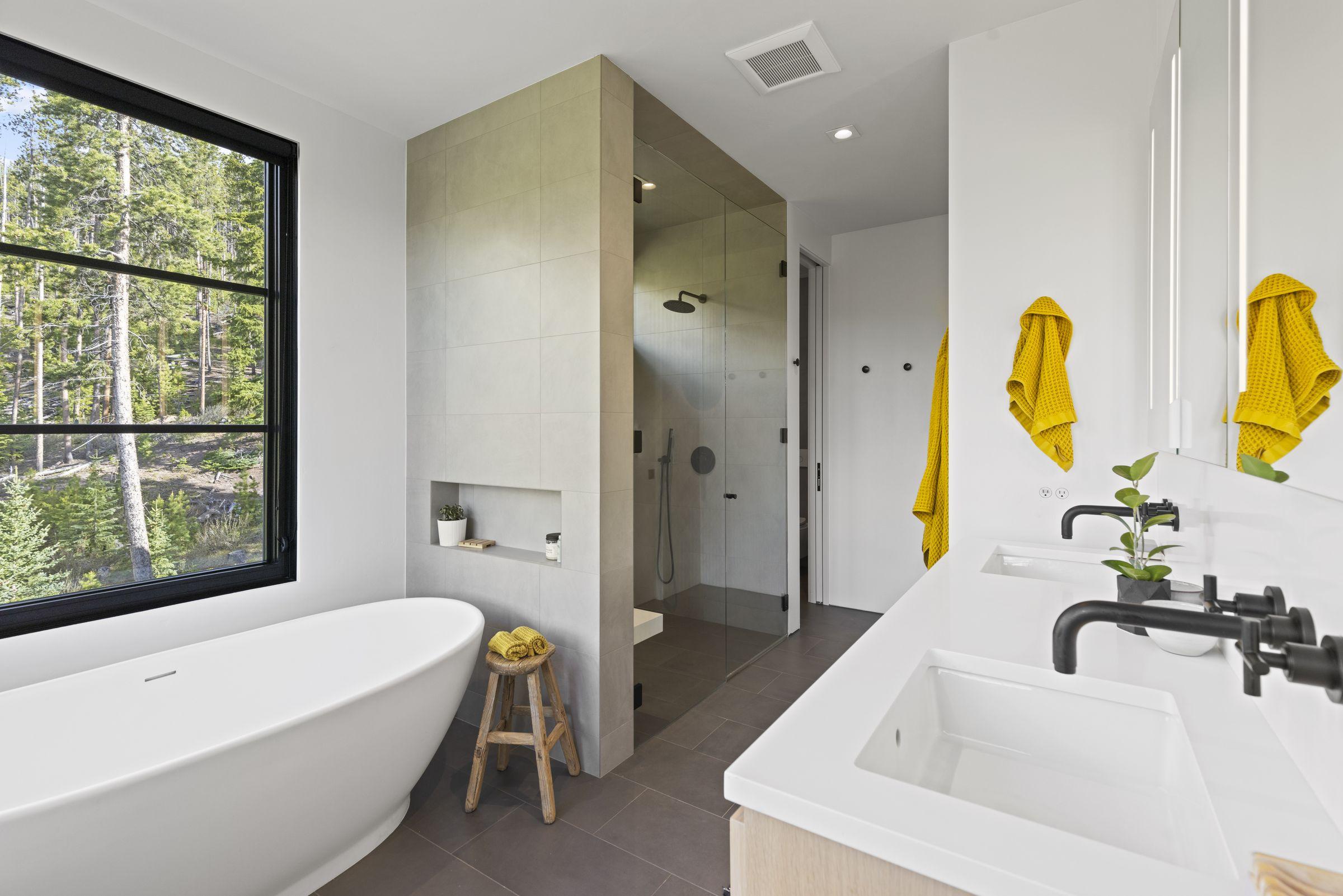 Bathroom with a freestanding tub and framed artwork