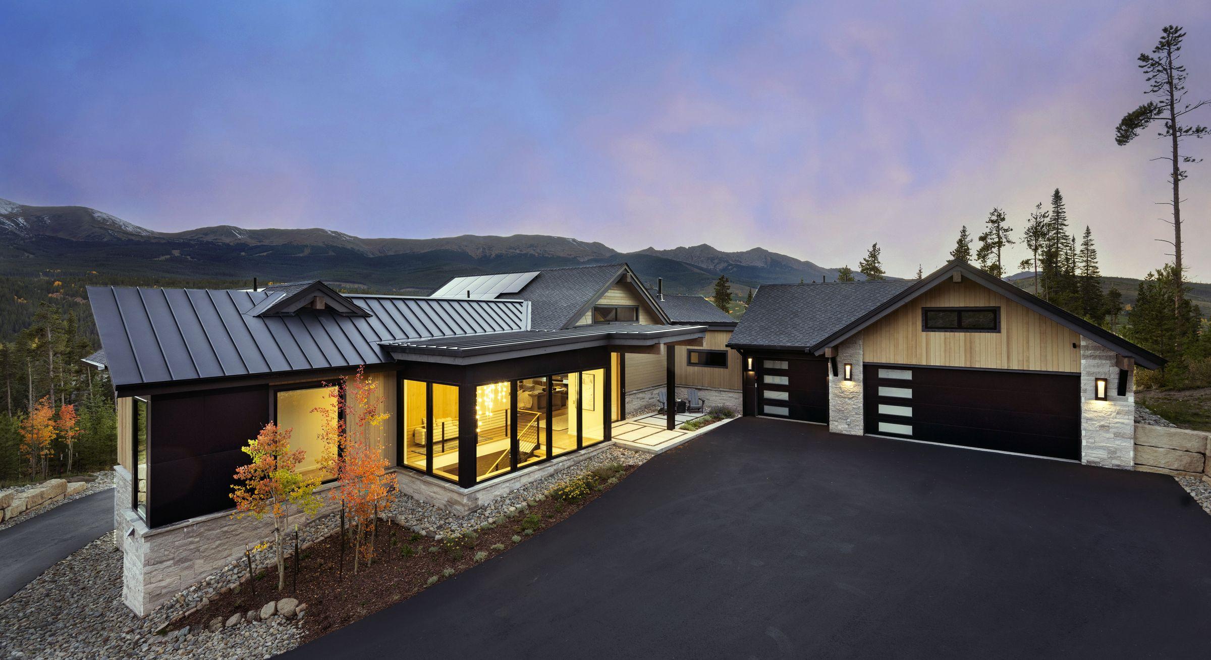 The Highlands residence at dusk, garage and entry lit, Breckenridge