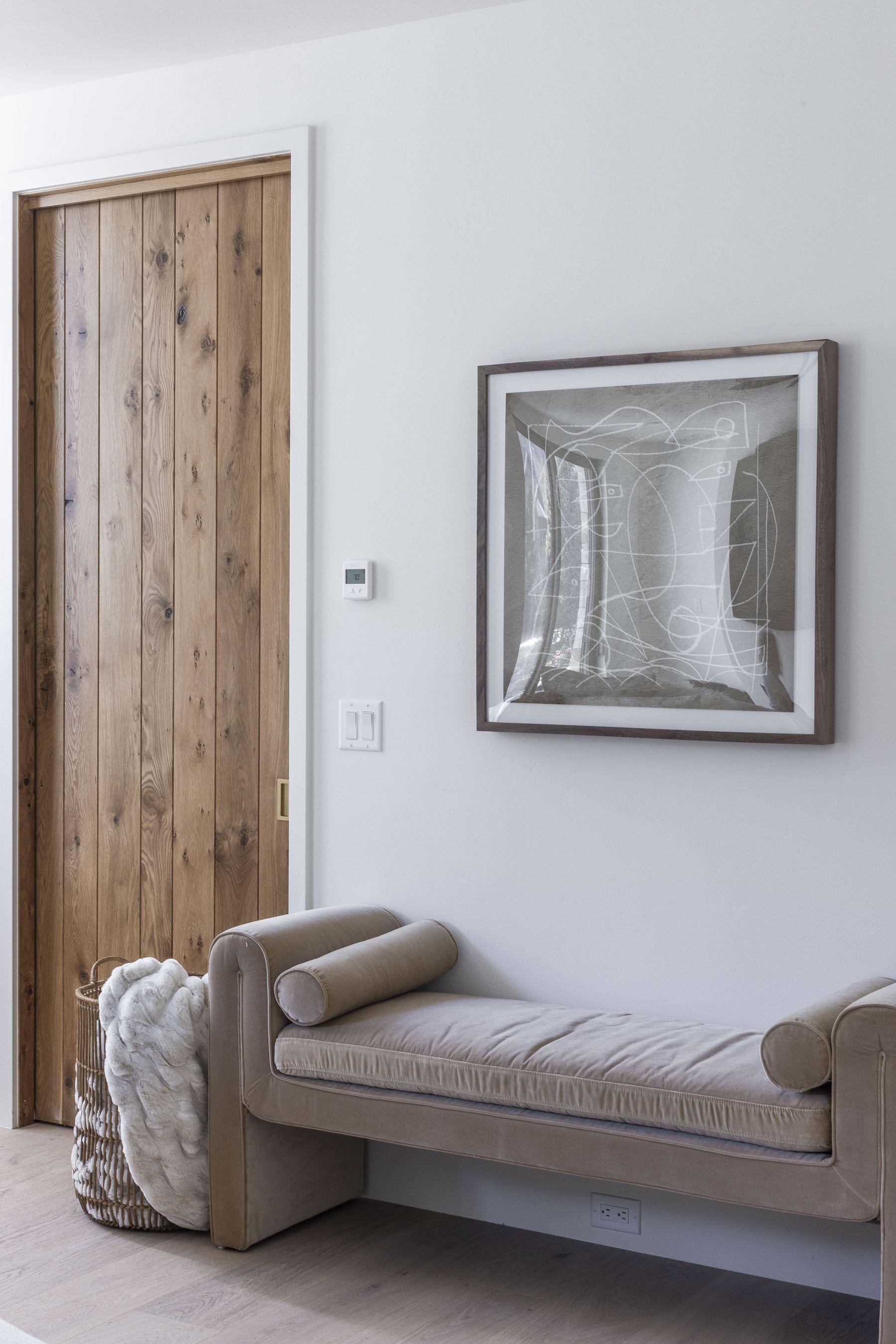 Entry with a sliding barn door and a bench beneath the mirror