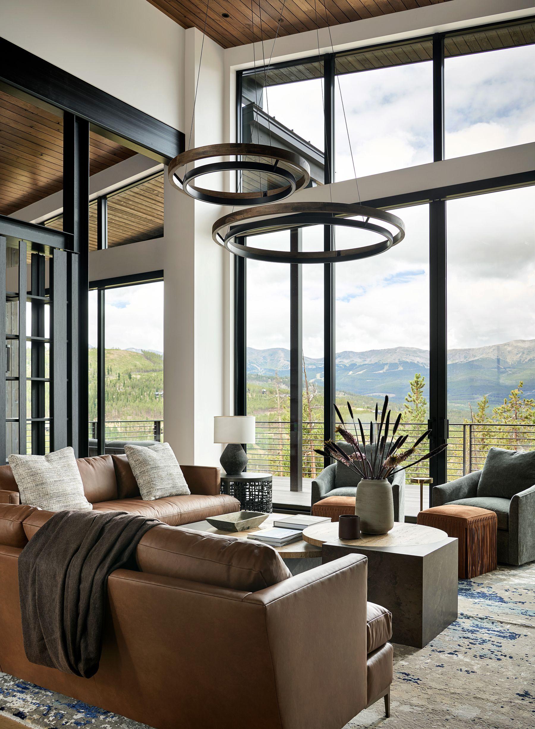 Sitting area in tan leather beneath a ring chandelier