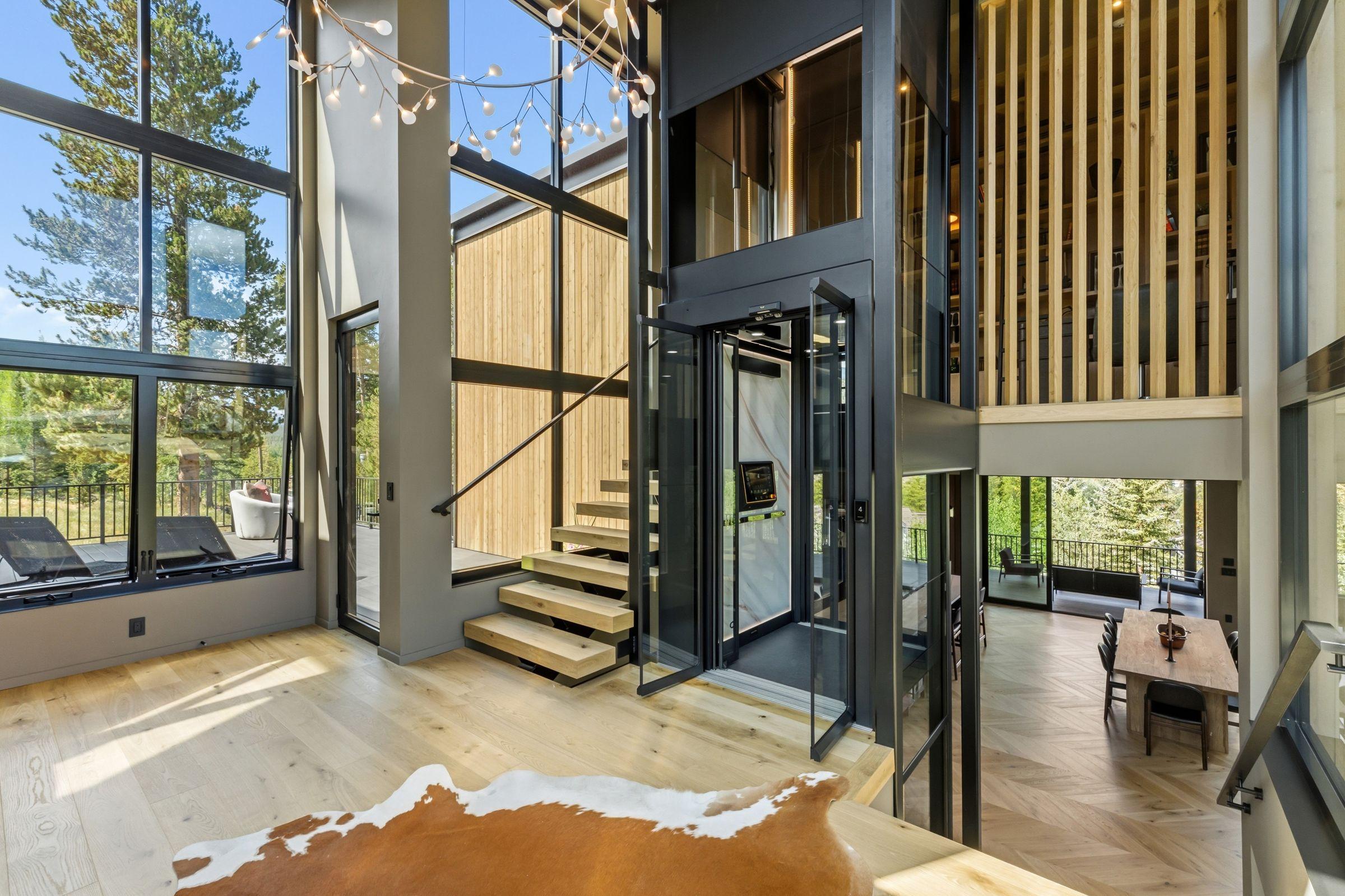 The glass elevator seen against slatted timber