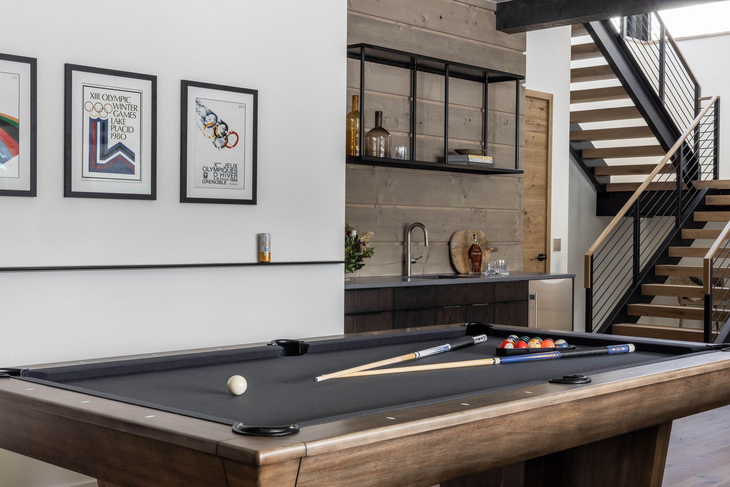 Games room with a pool table, the stair rising behind