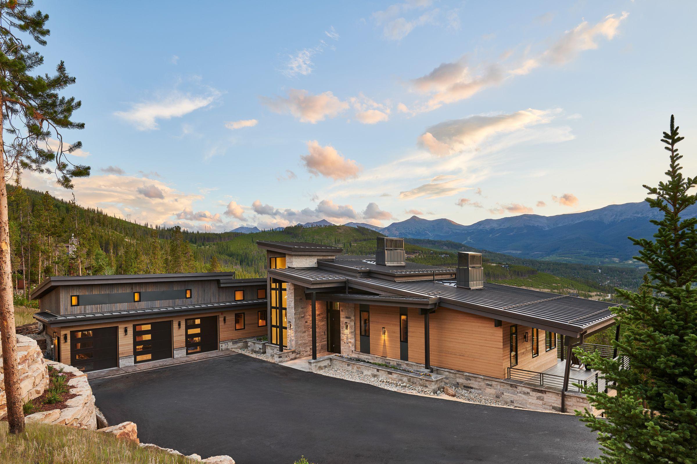 Approach and driveway at dusk, the peaks behind the house