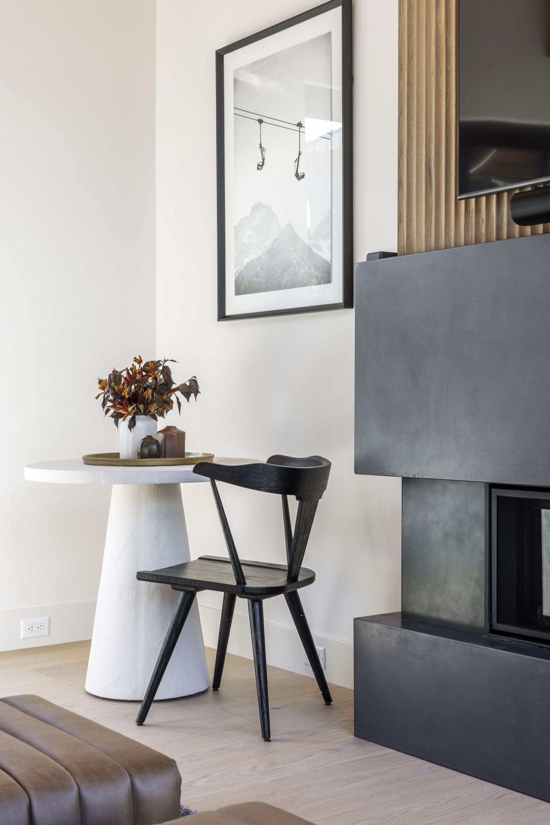 Blackened linear fireplace against a white wall