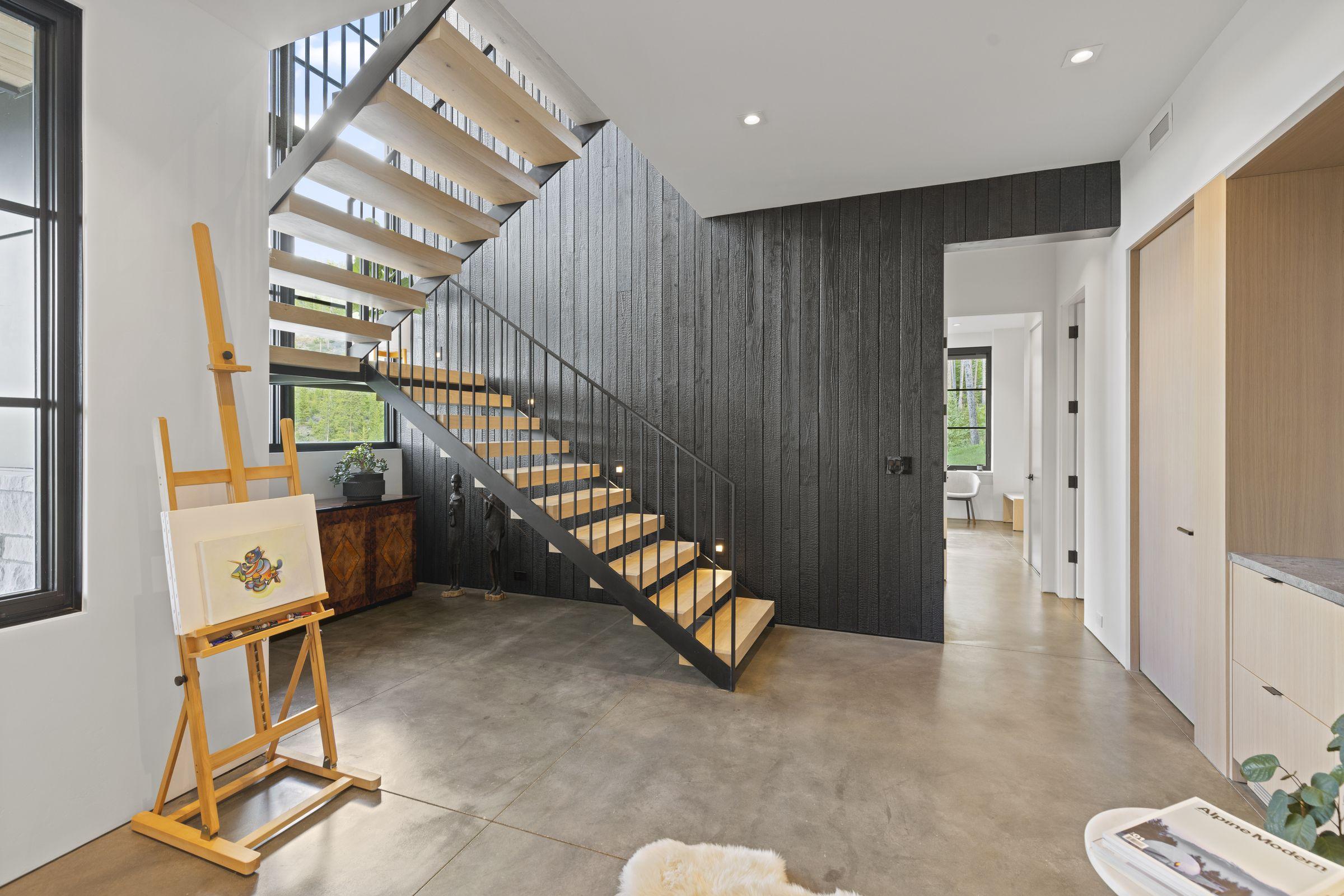 Entry hall with a floating stair over a polished concrete floor