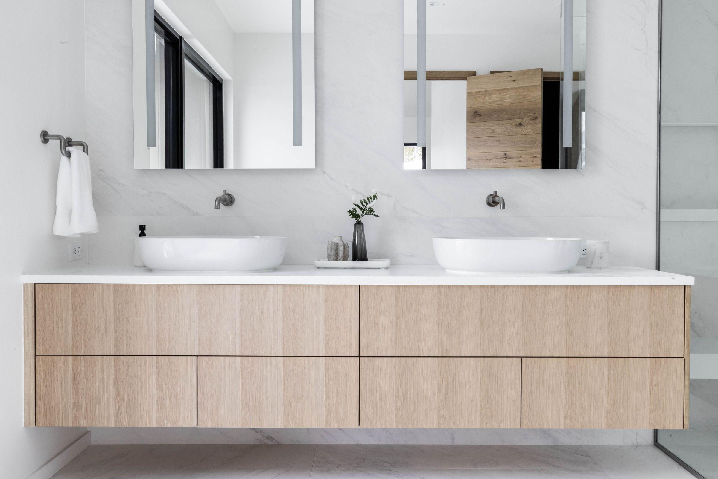Bathroom with a double vanity and round mirrors