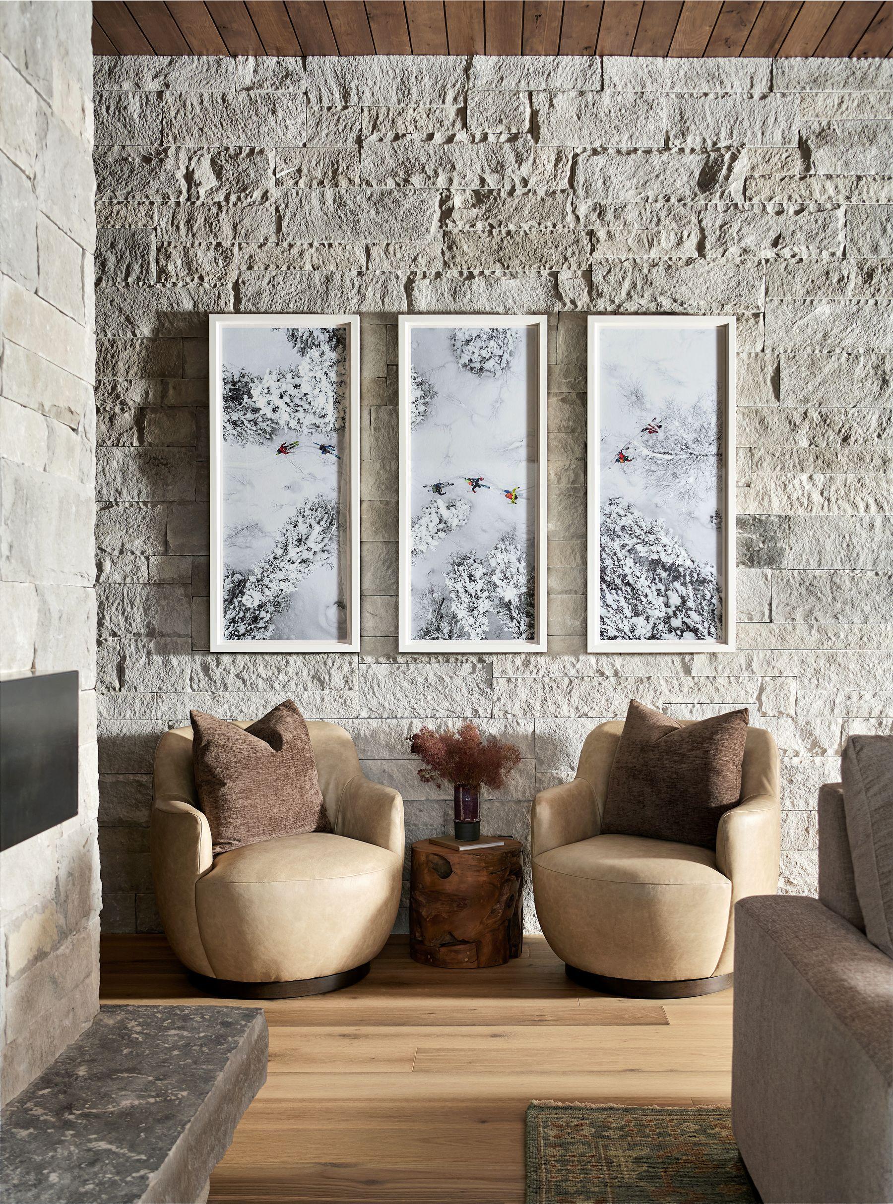Reading nook with three framed prints hung on the stone chimney