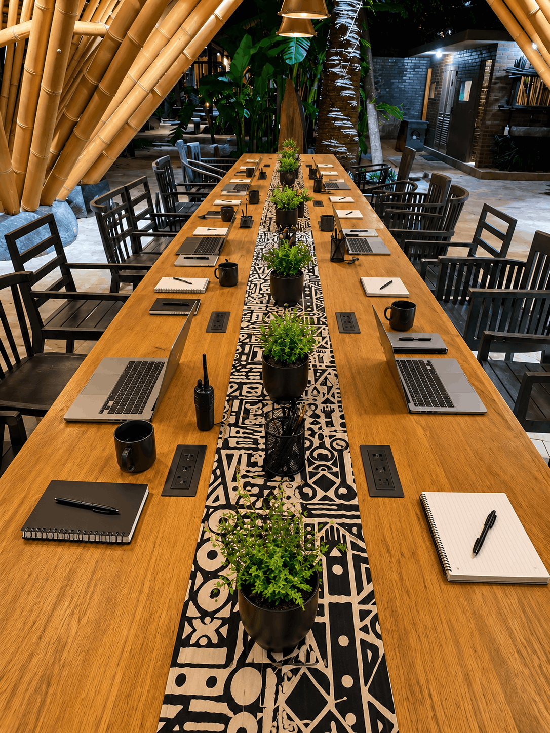 A live-edge wooden dining table set beneath the restaurant's arched bamboo ceiling.
