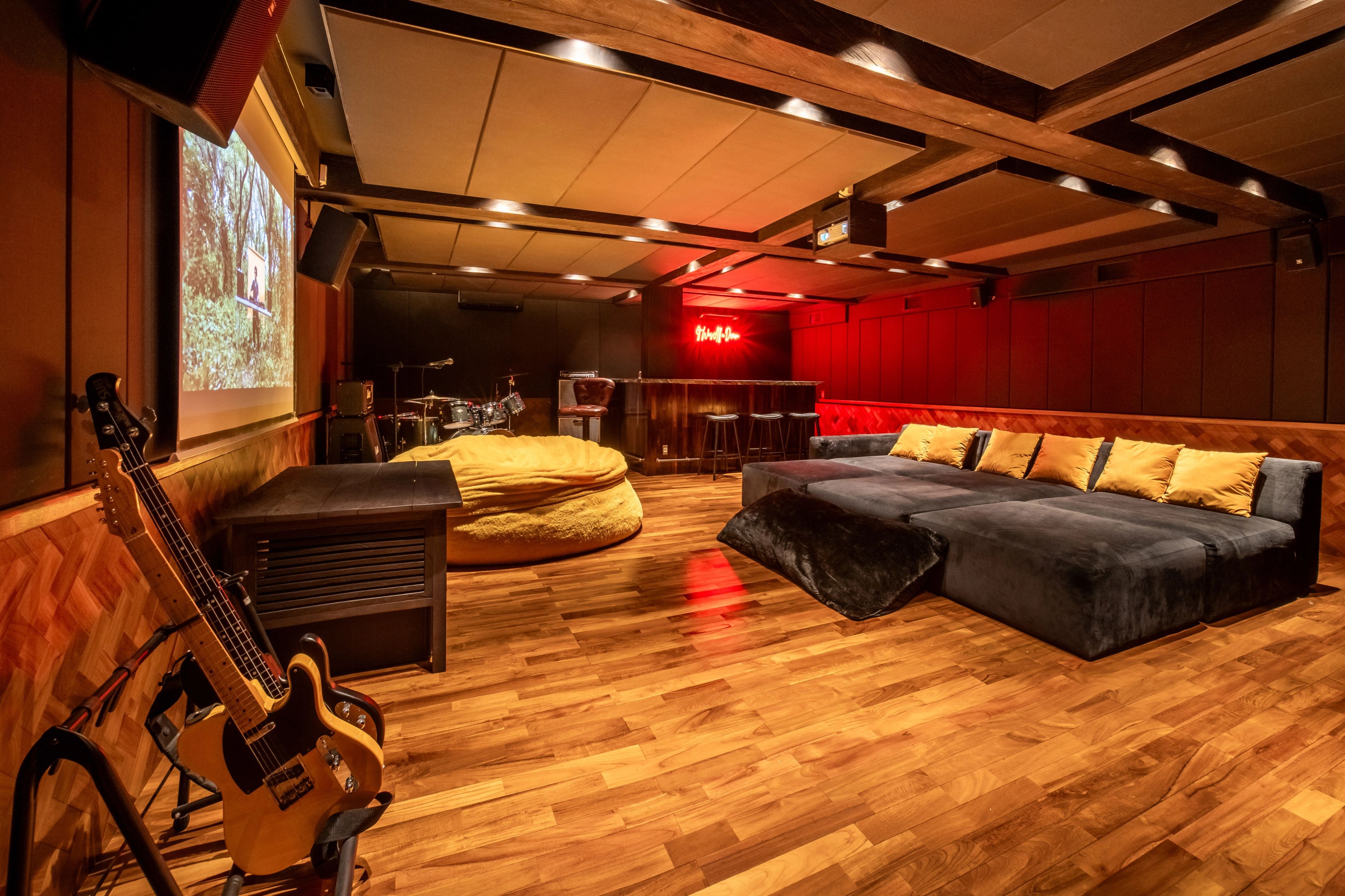 Basement lounge set up with a projector screen for movie nights.