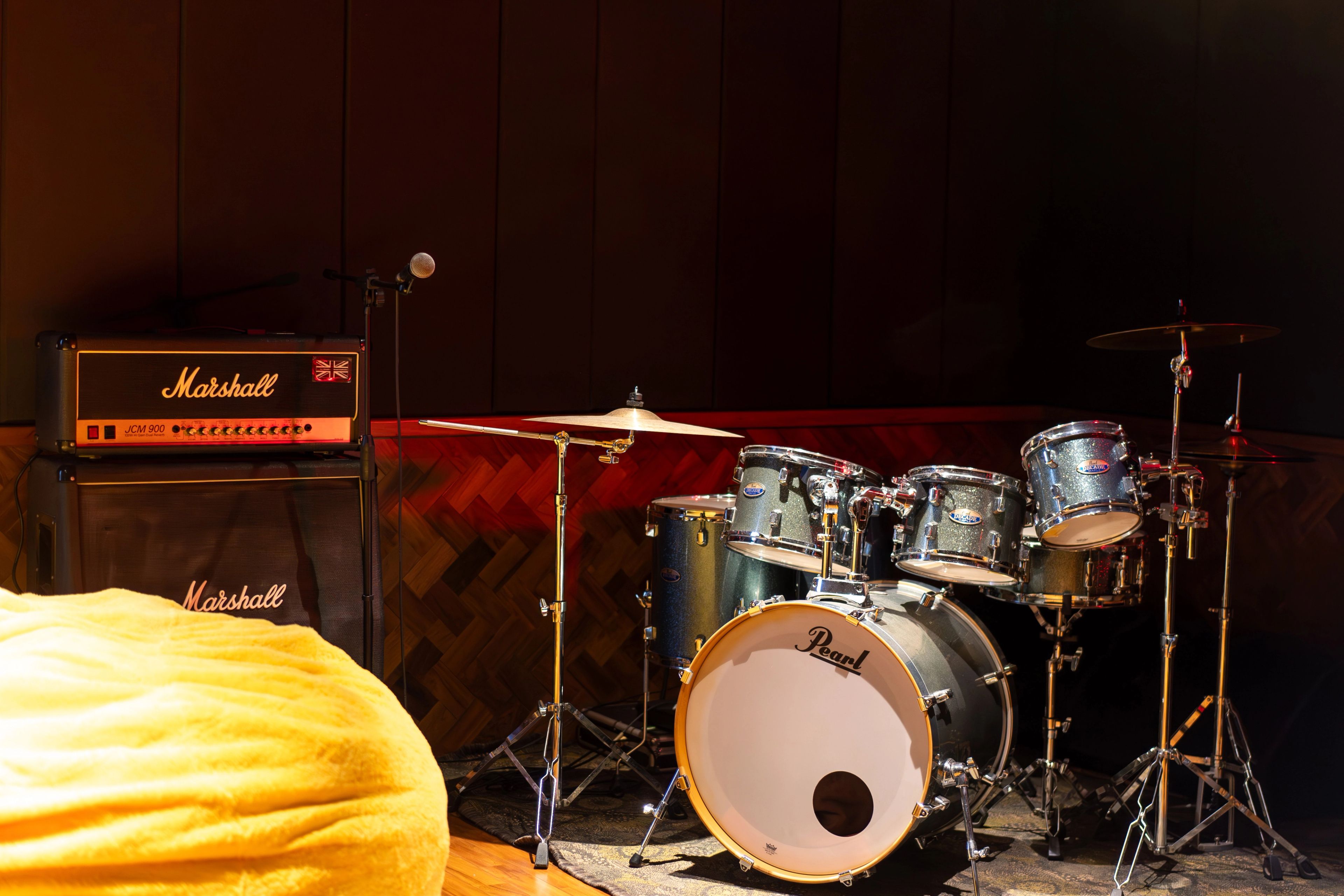 A drum kit and Marshall amplifiers in the subterranean recording studio.