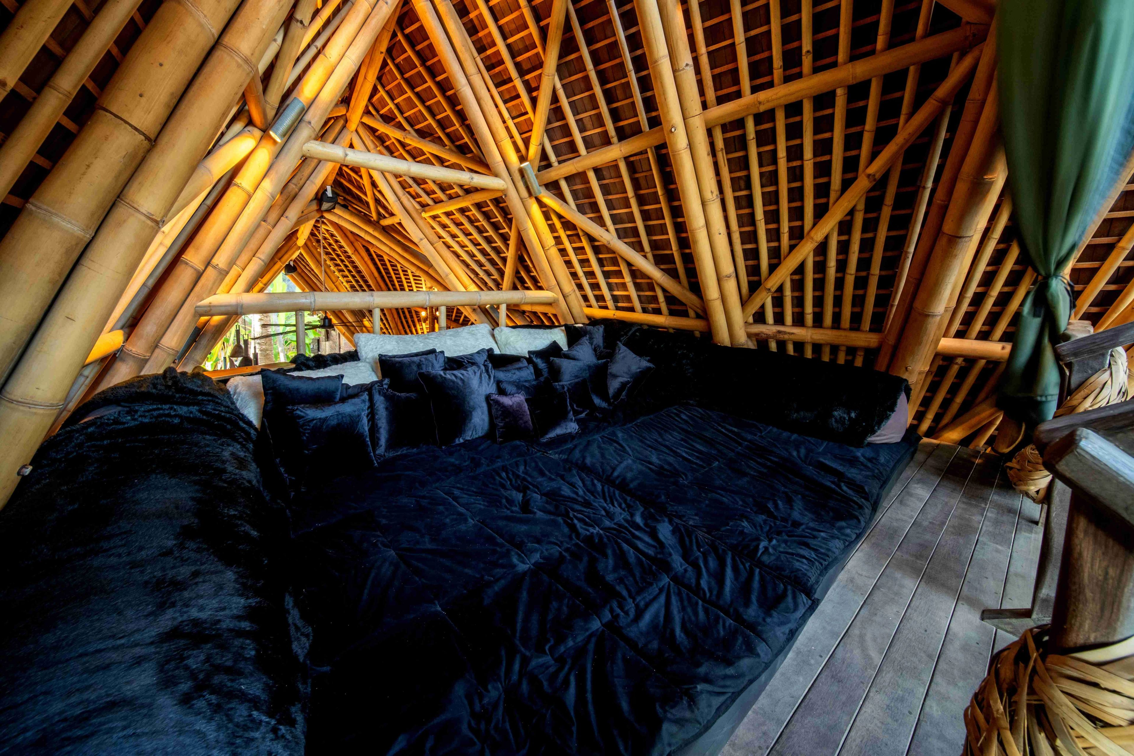 The empty timber deck under its woven canopy, looking out past the rope sculpture to the reef.