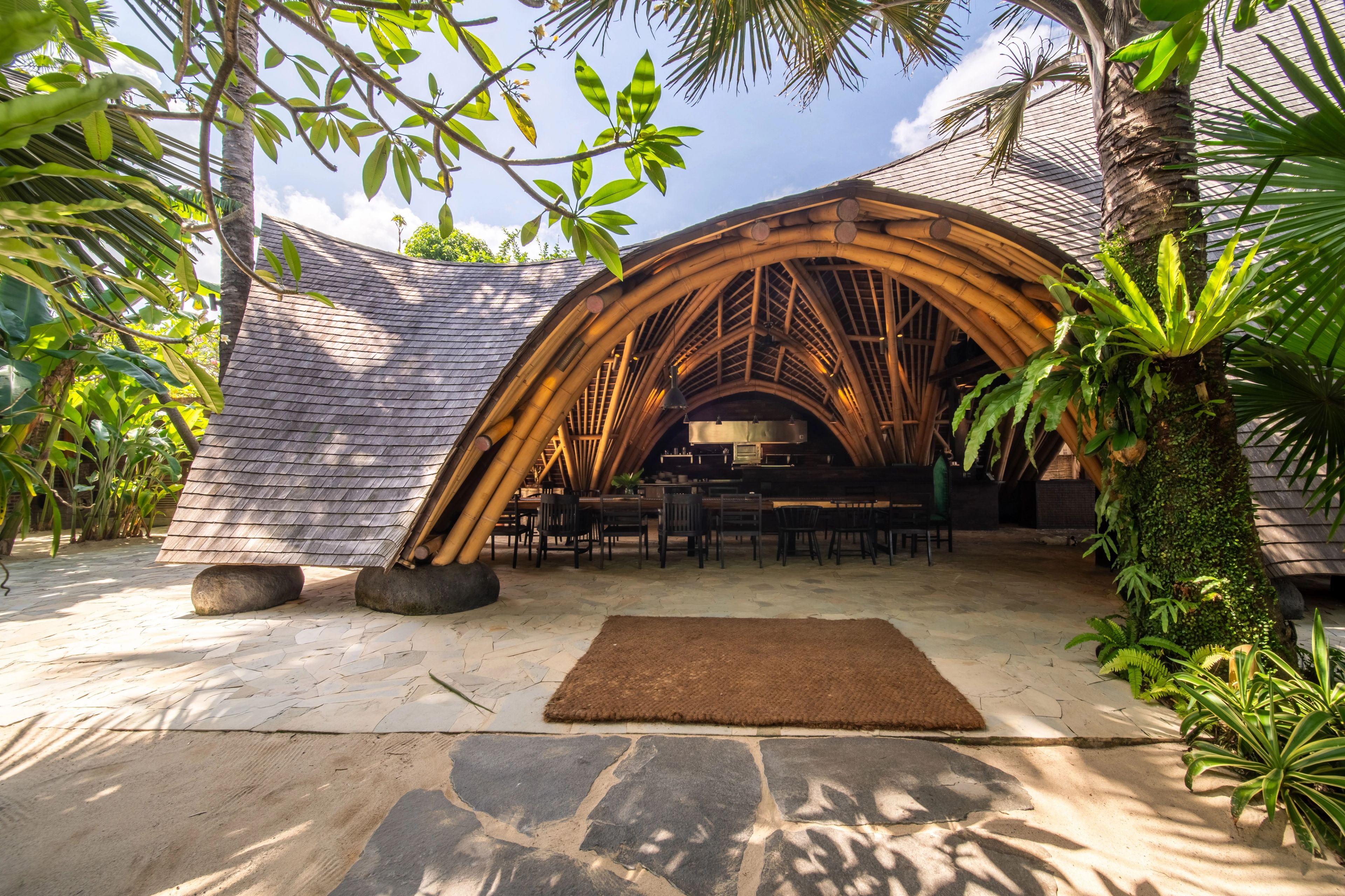The restaurant's dramatic bamboo-vaulted dining hall with long communal tables.