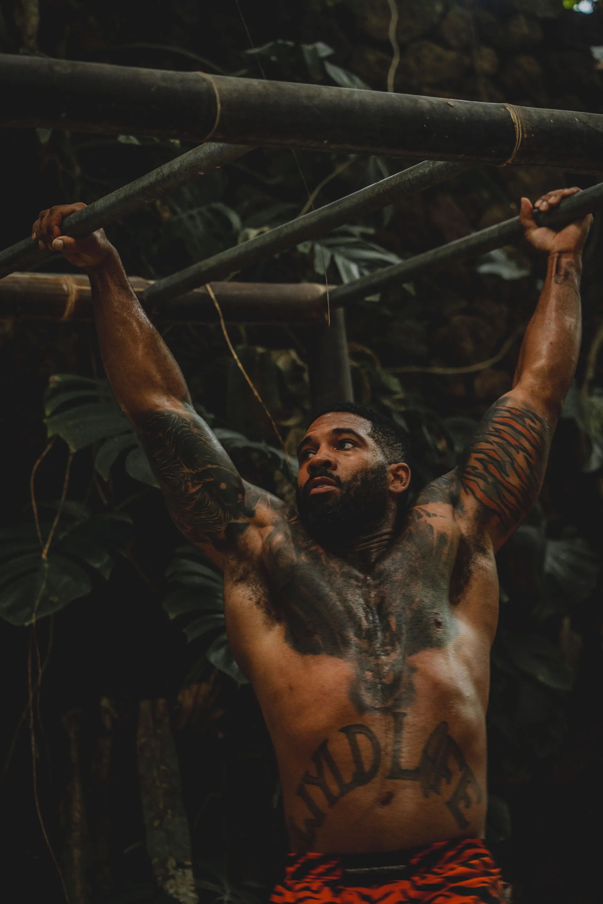 A guest training on the pull-up bar in the open-air jungle gym.