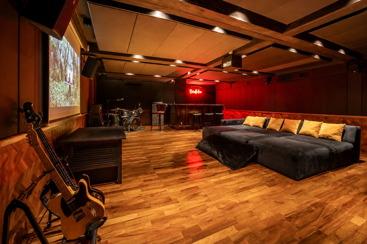 Basement lounge set up with a projector screen for movie nights.