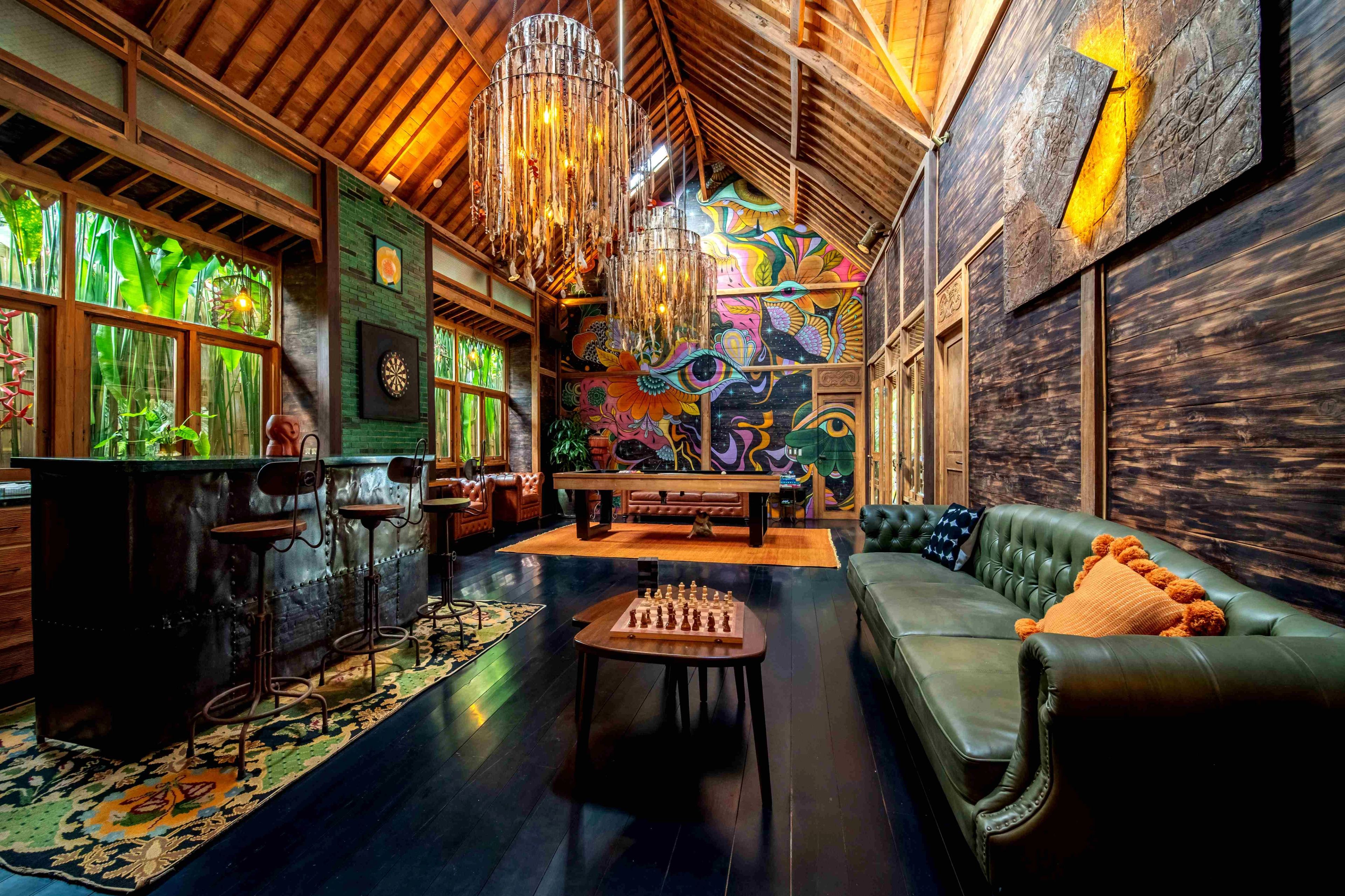 Games room with pool table and sofas opening onto the outdoor deck.