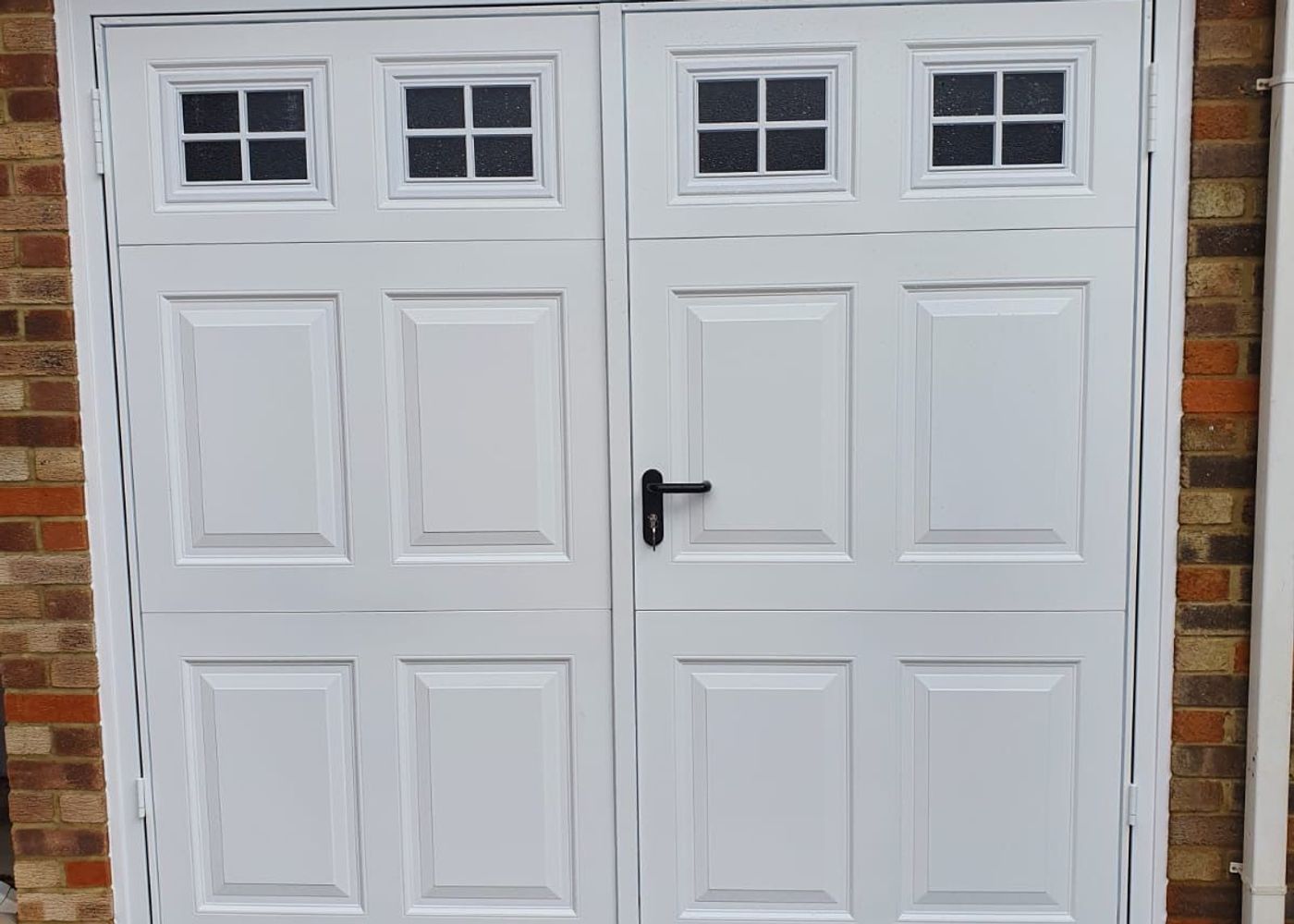 White timber side hung garage doors