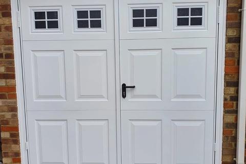 Side-hinged garage doors