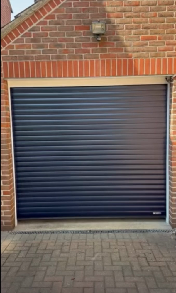 New anthracite insulated Aluroll 77 Secured by Design roller garage door fitted behind the opening in Church Langley