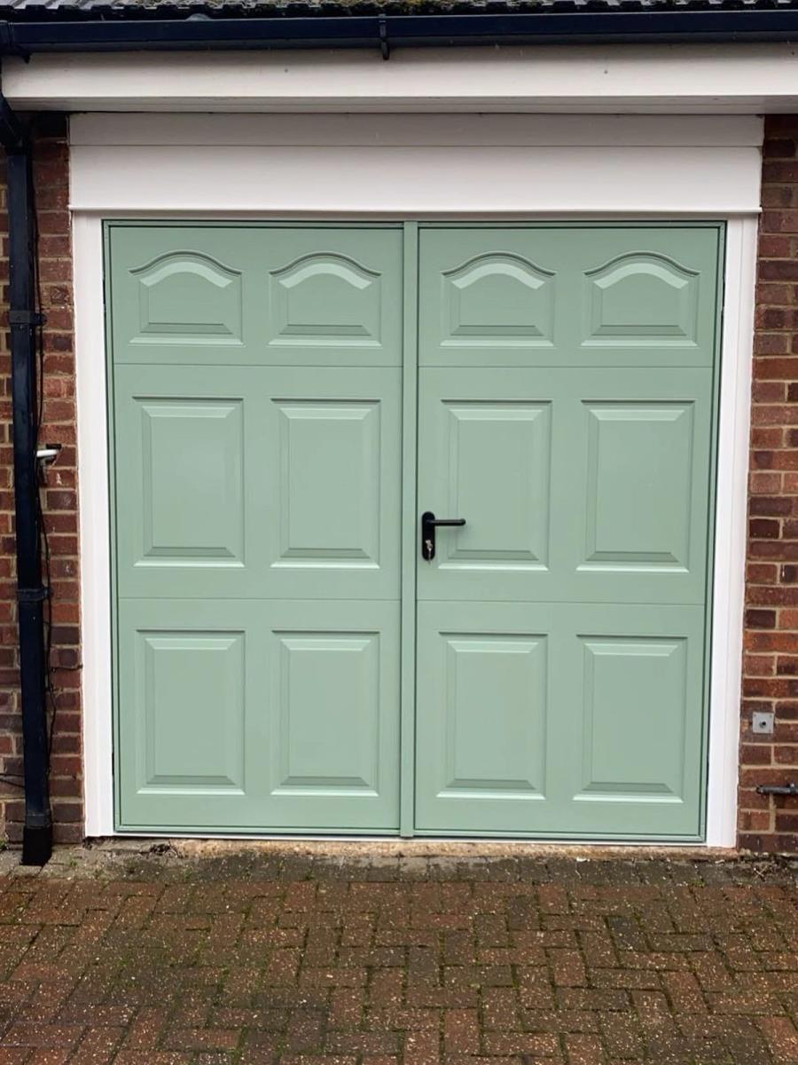 Green Garador Cathedral side-hinged garage doors