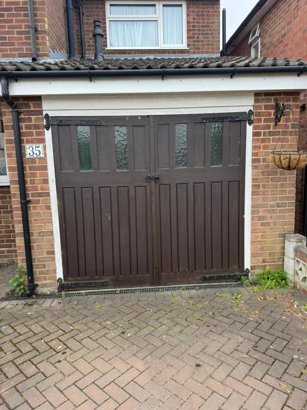 Old timber garage doors removed in Ware to make way for a new roller door