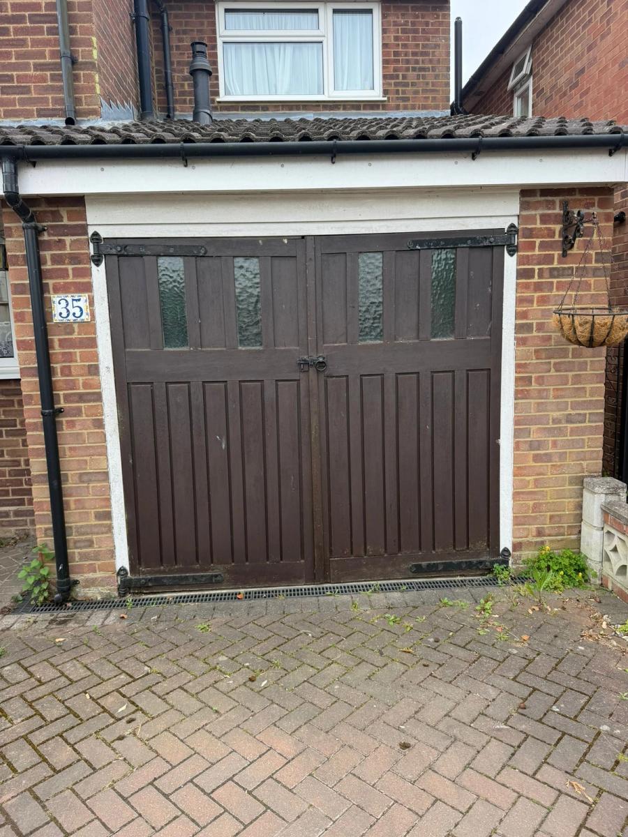 Old timber garage doors removed in Ware to make way for a new roller door