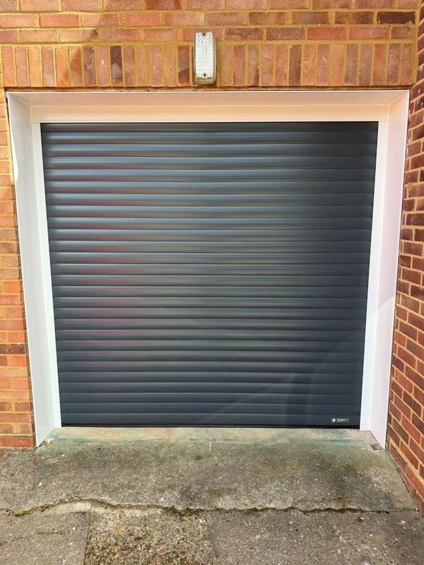 New black Aluroll Classic 77 insulated and alarmed roller garage door in Hertford
