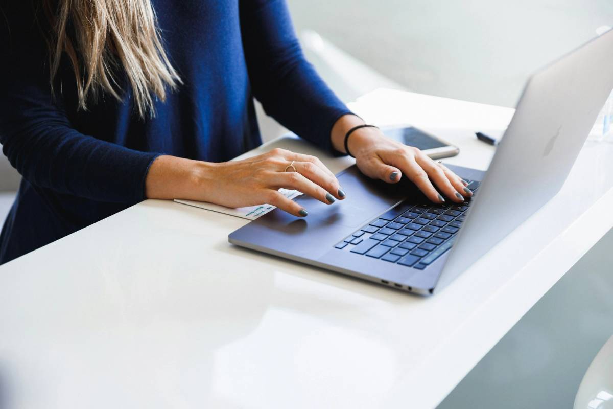 Operations manager reviewing tasks handled by AI agents for business on a laptop