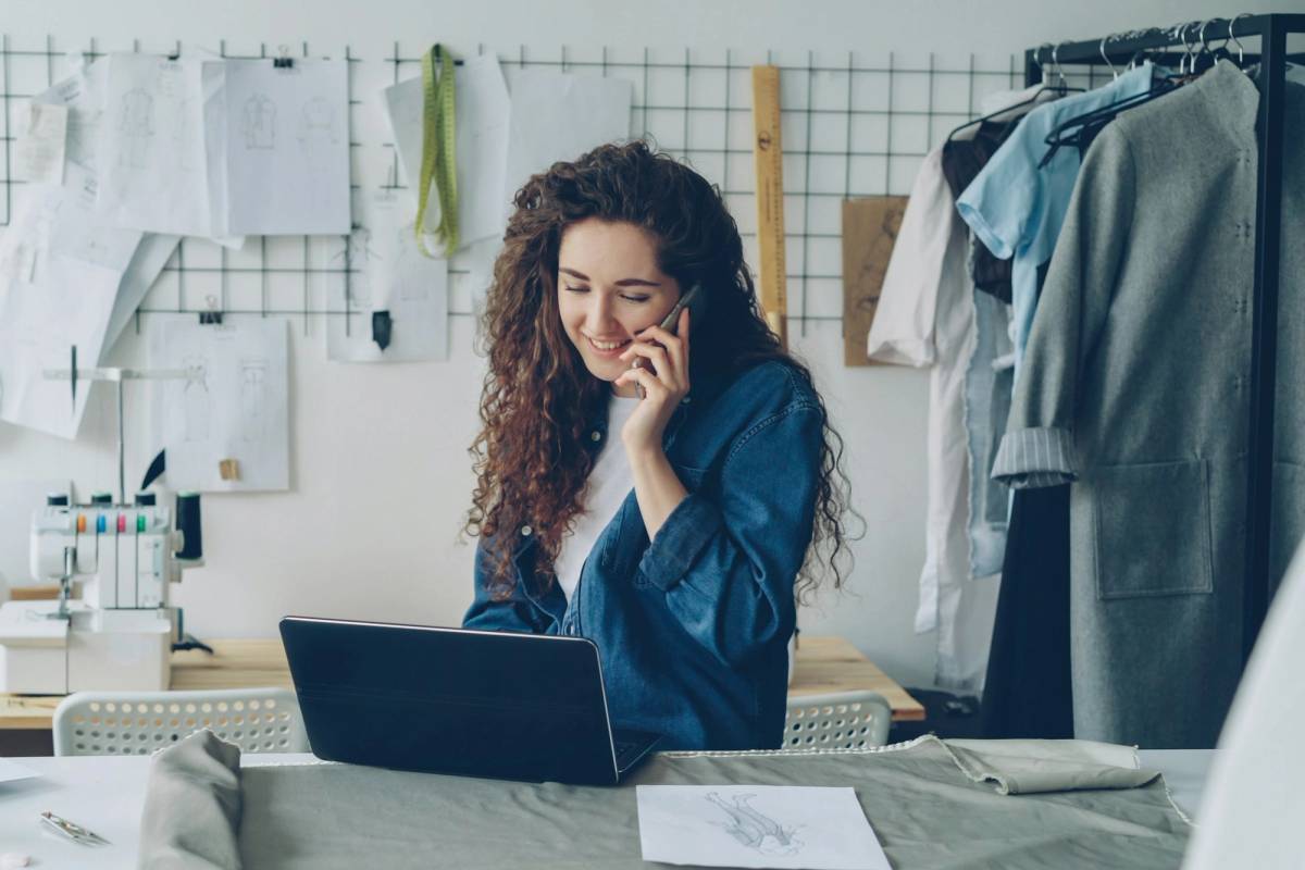 Small business owner reviewing AI automation for small business workflows on a laptop