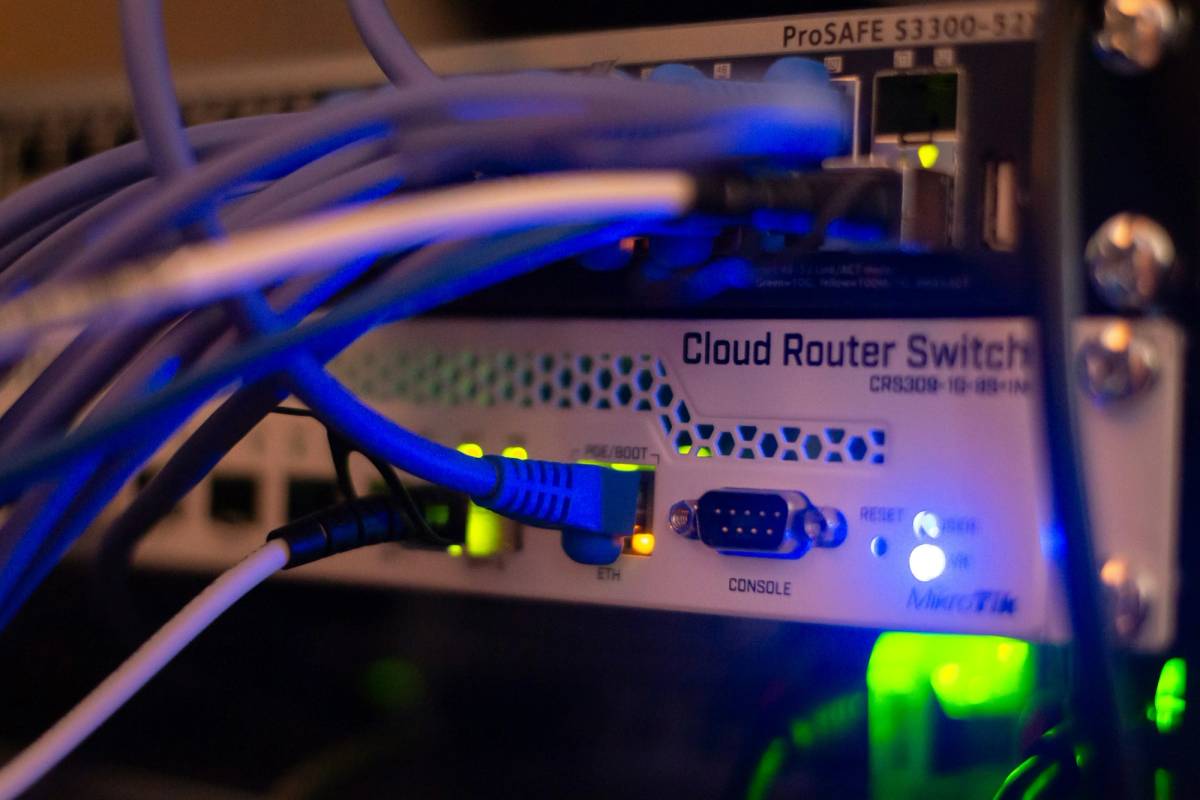 IT technician unplugging an old server during an application decommissioning project