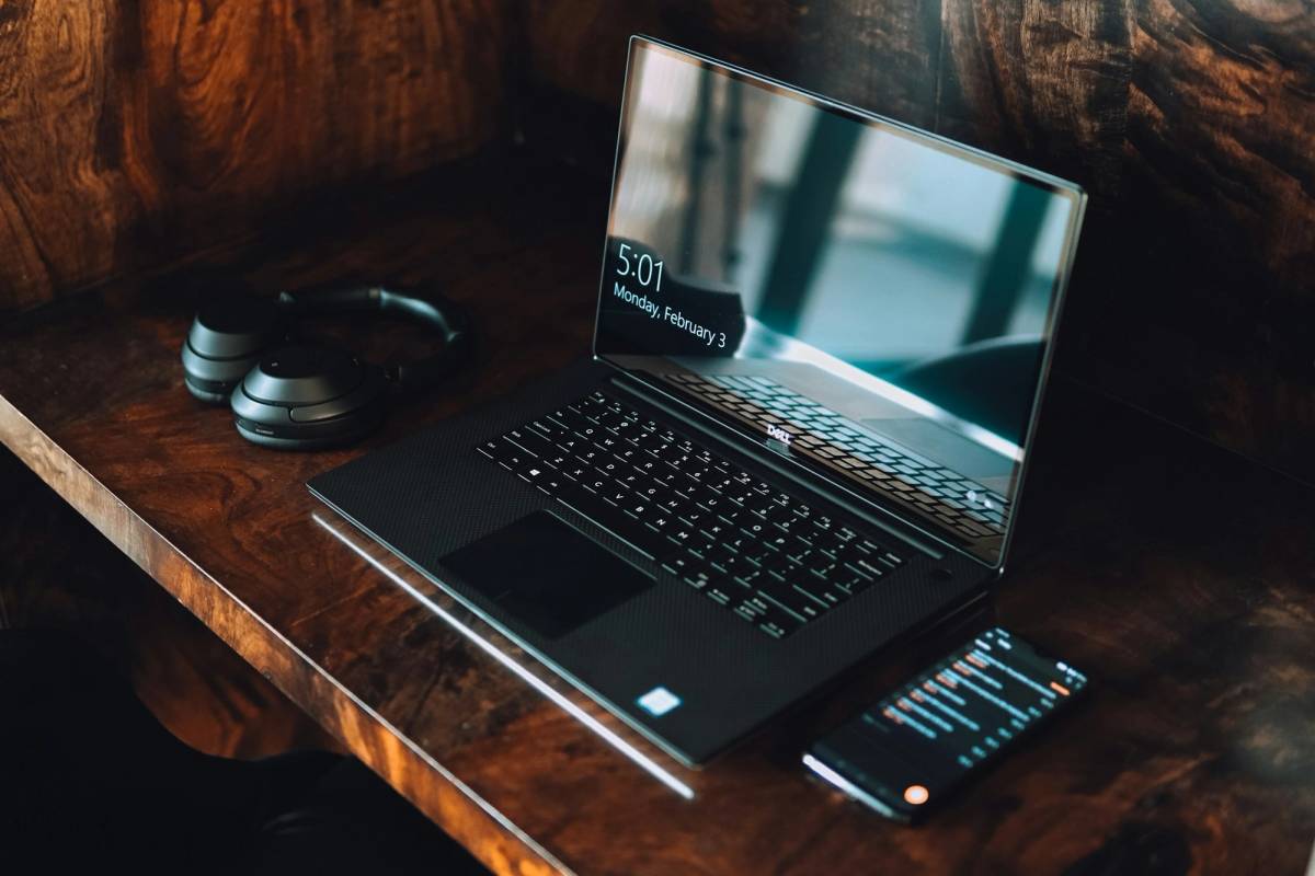 black asus laptop computer on brown wooden table