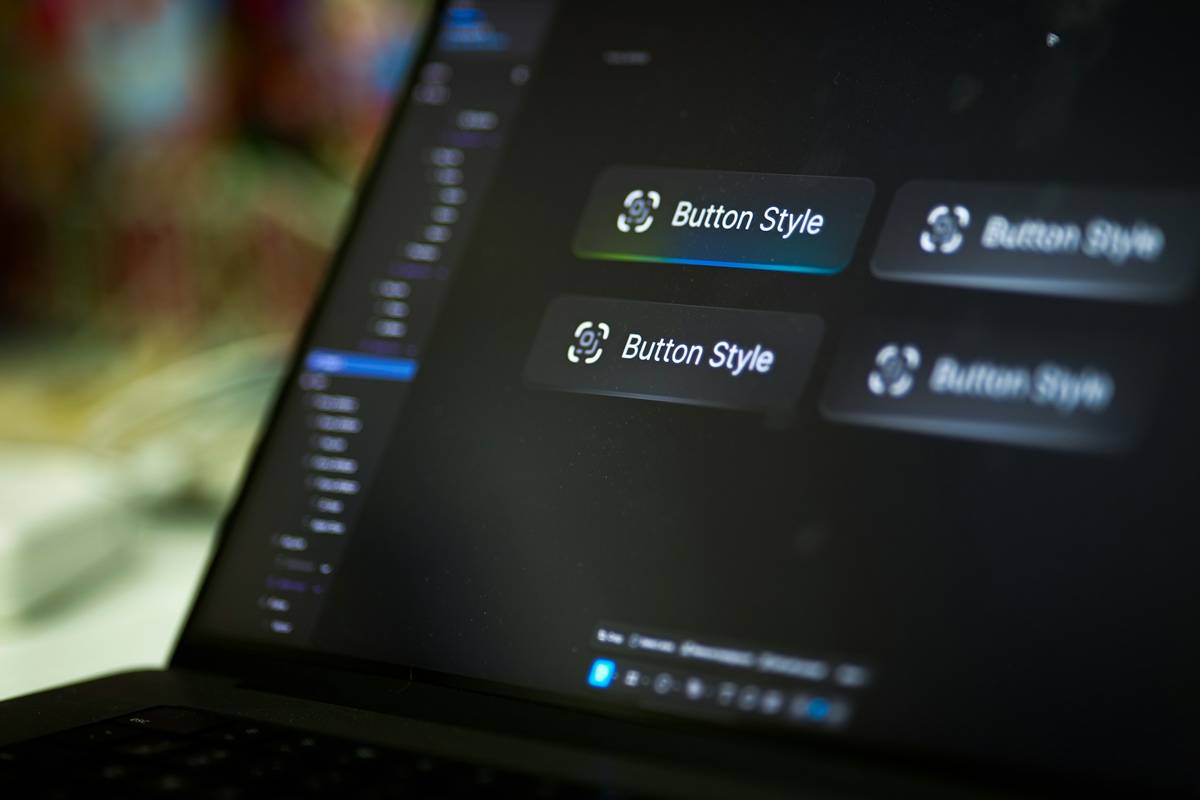 Laptop screen displays four button style options.