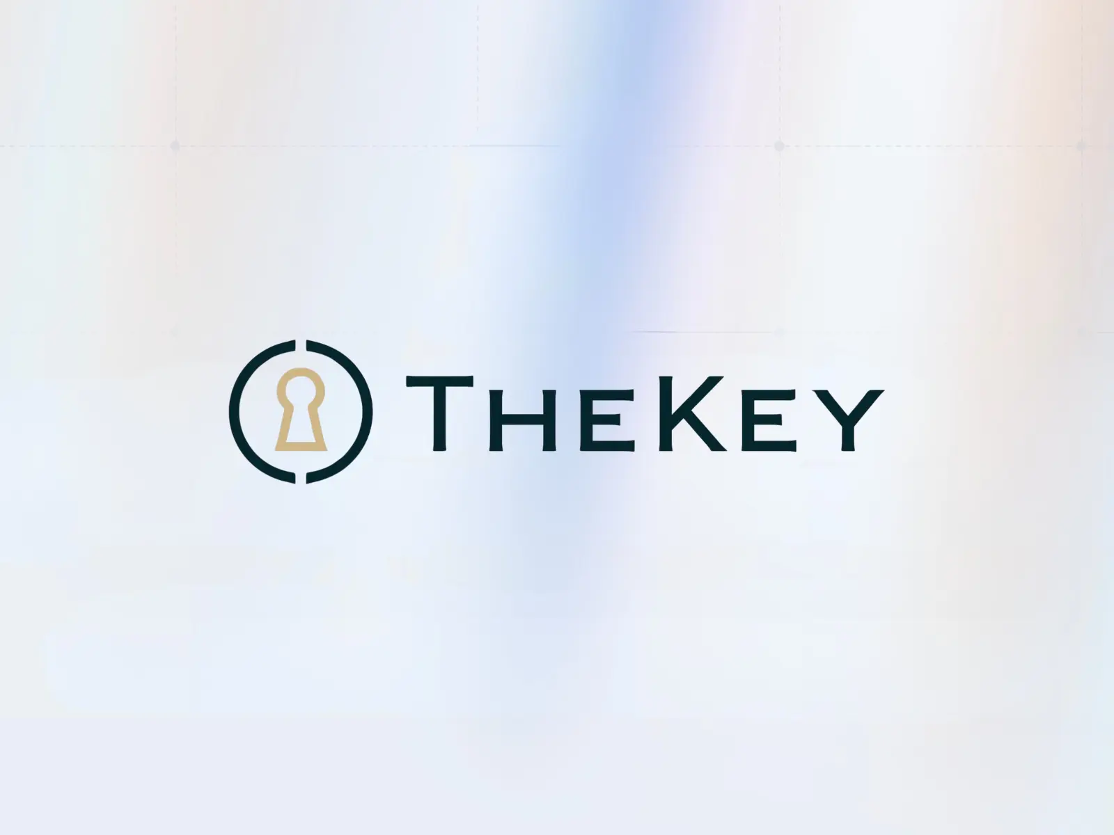 The logo for THE KEY, featuring a dark blue circle with a small opening at the top and bottom, surrounding a gold keyhole shape. The dark blue text "THE KEY" is next to the icon, all set against a blurred light blue and white background.