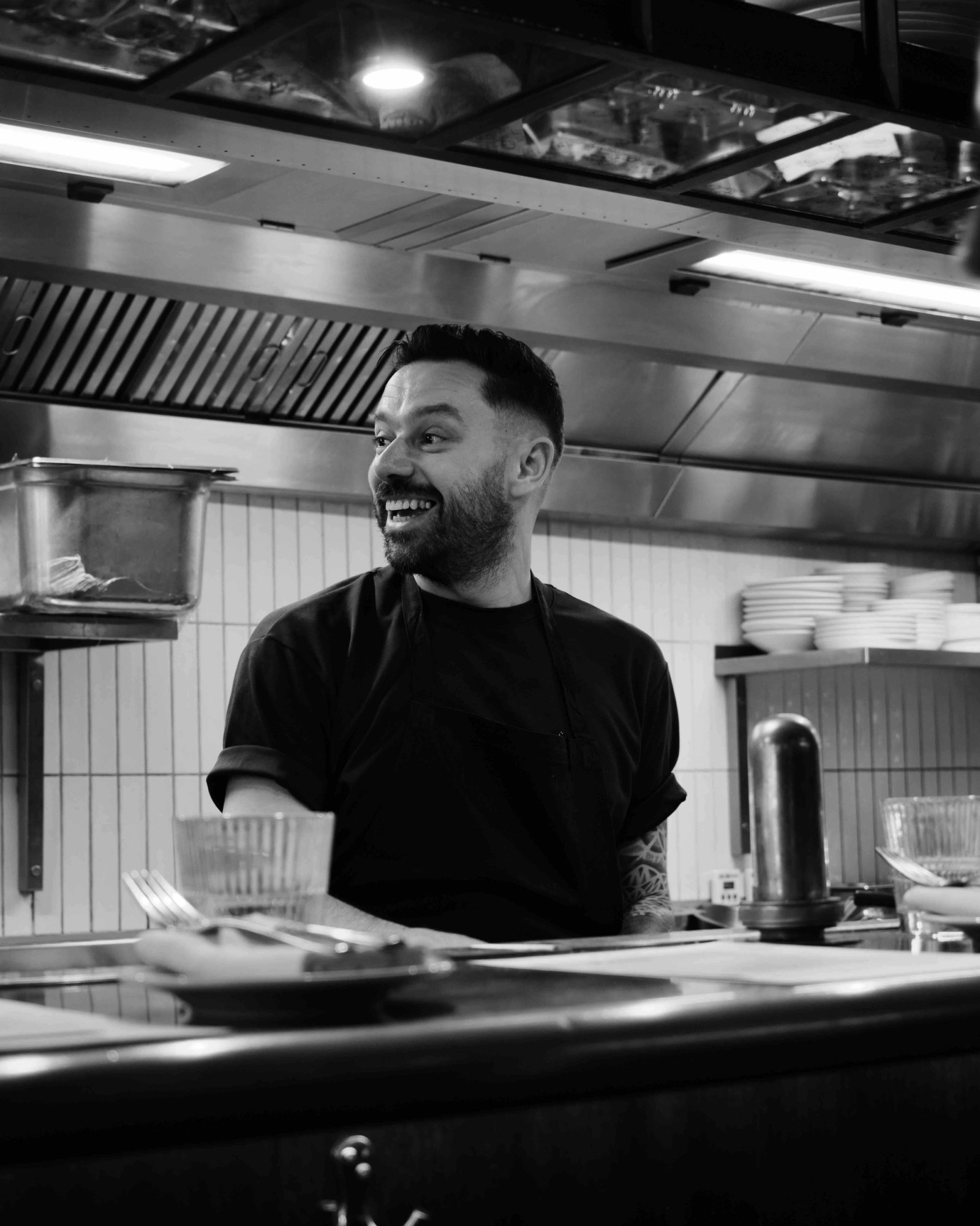 Chef preparing signature dishes at The Palomar kitchen counter
