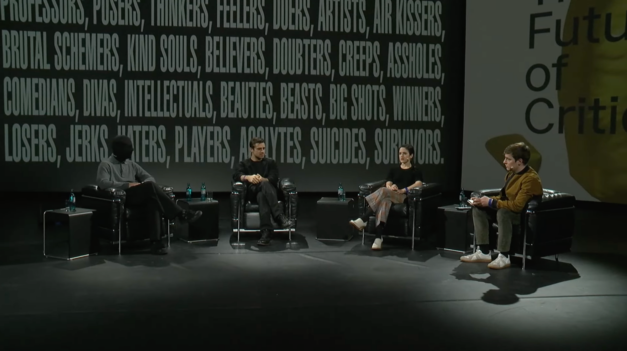 four people on stage in a panel setting
