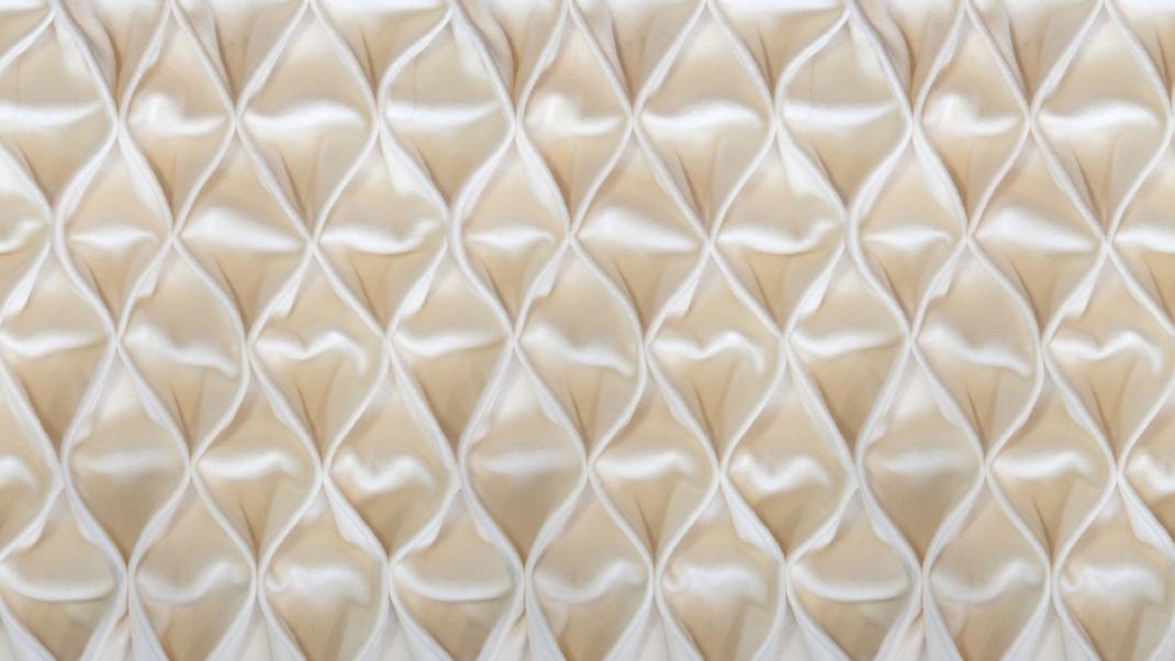 Sand-colored wallpaper with soft fabric in a diamond pattern