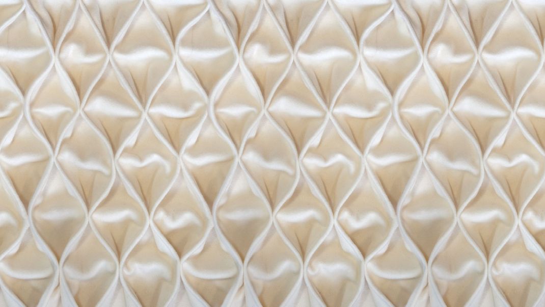 Sand-colored wallpaper with soft fabric in a diamond pattern