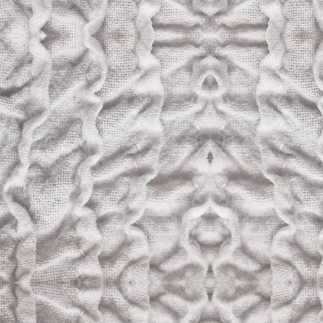 Gray wallpaper with folded white textile