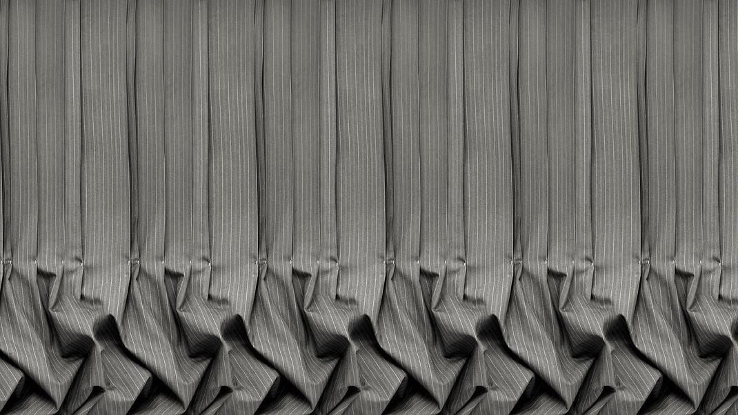 Grey wallpaper with folded textile