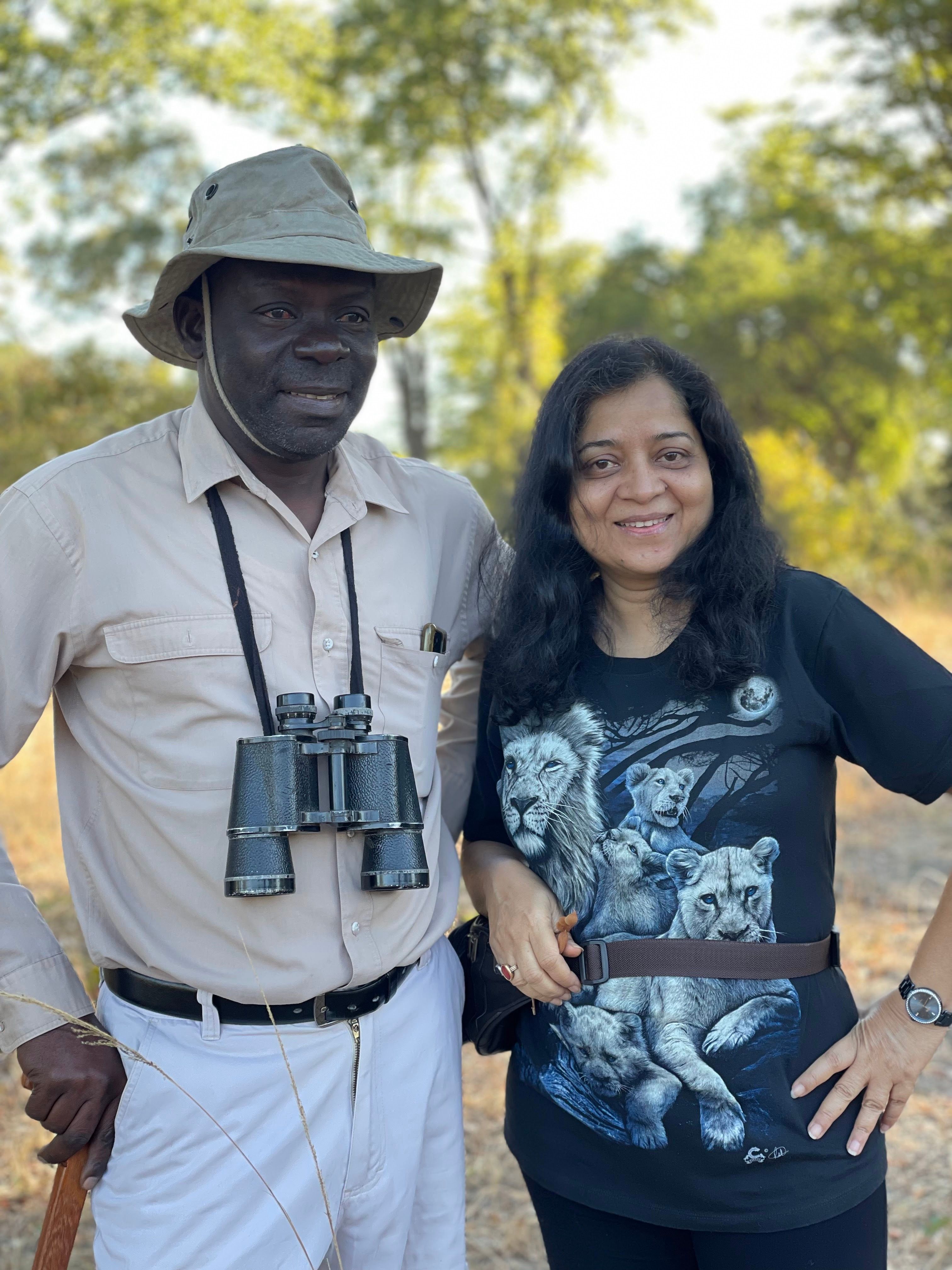 Hemakshi with a guide carrying binoculars