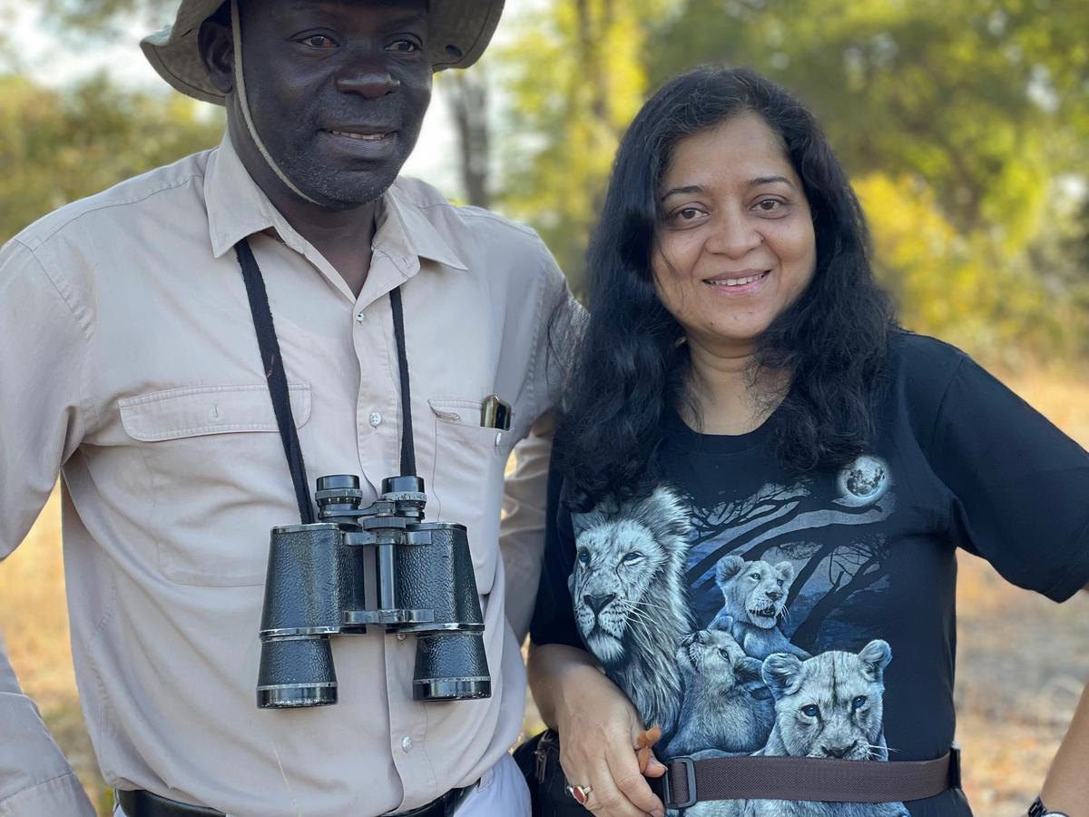 Hemakshi with a guide carrying binoculars